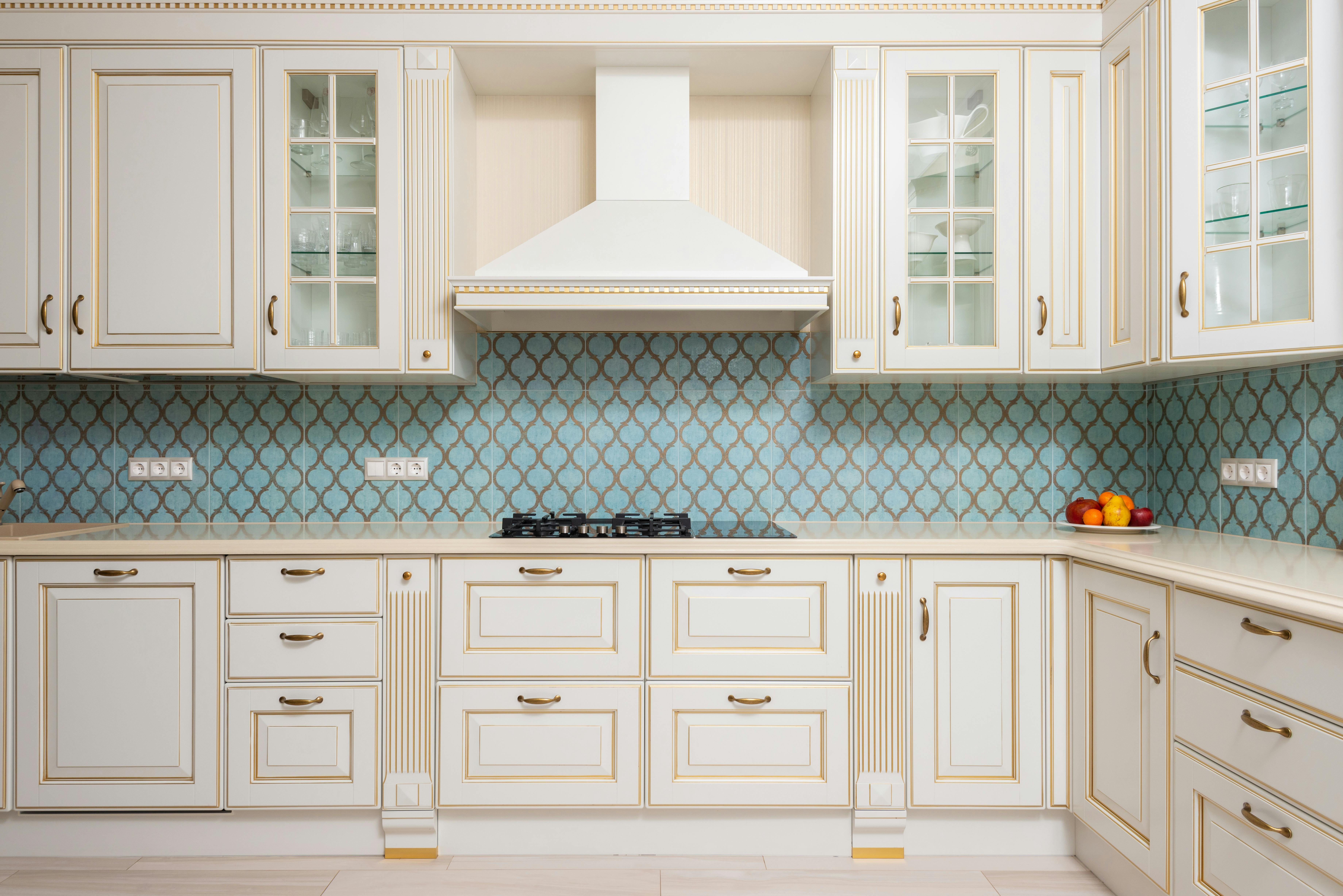 Antique cream kitchen cabinets featuring intricate detailing for a classic, timeless look.