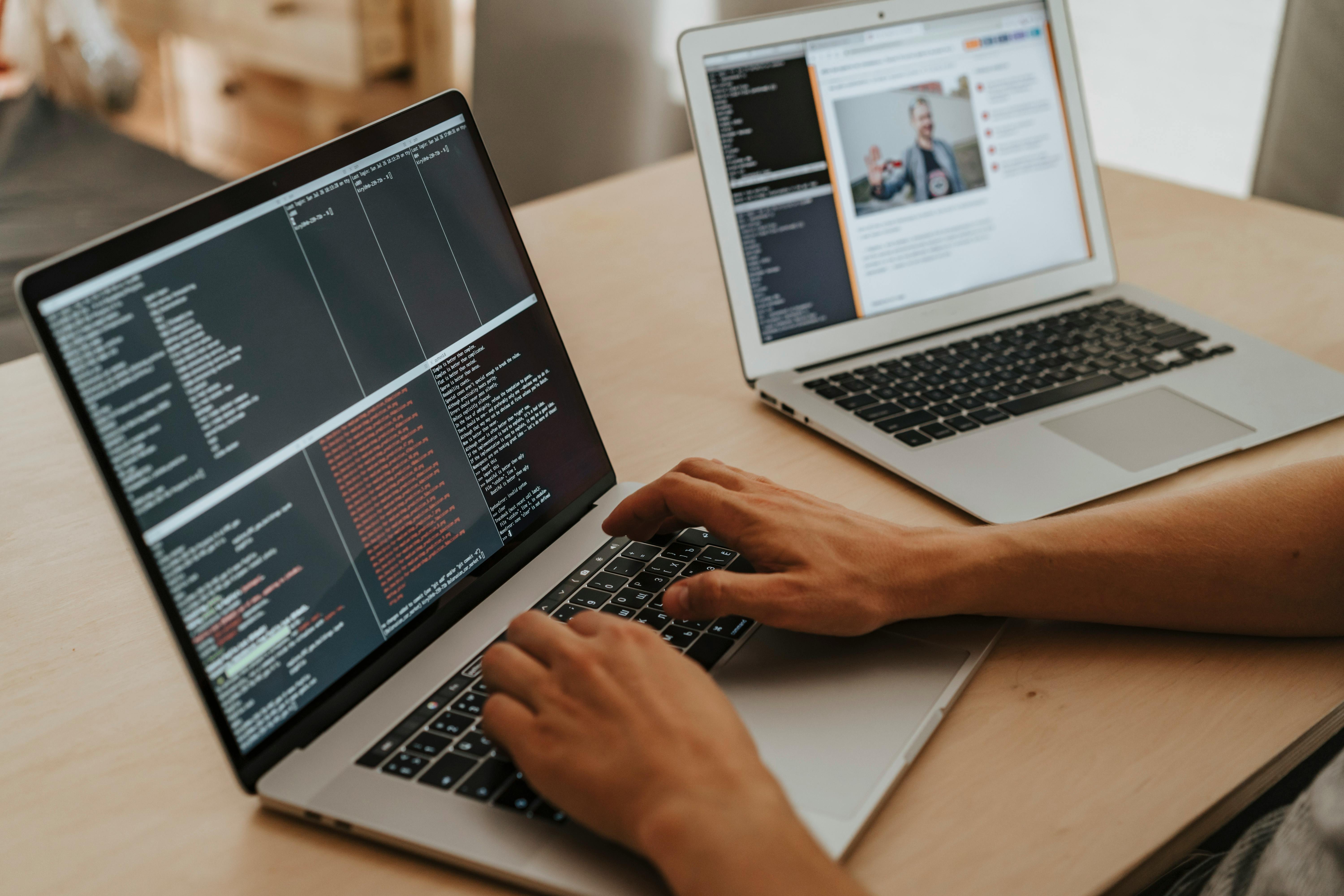 Person coding on a MacBook Pro, representing an architect transitioning into IT.