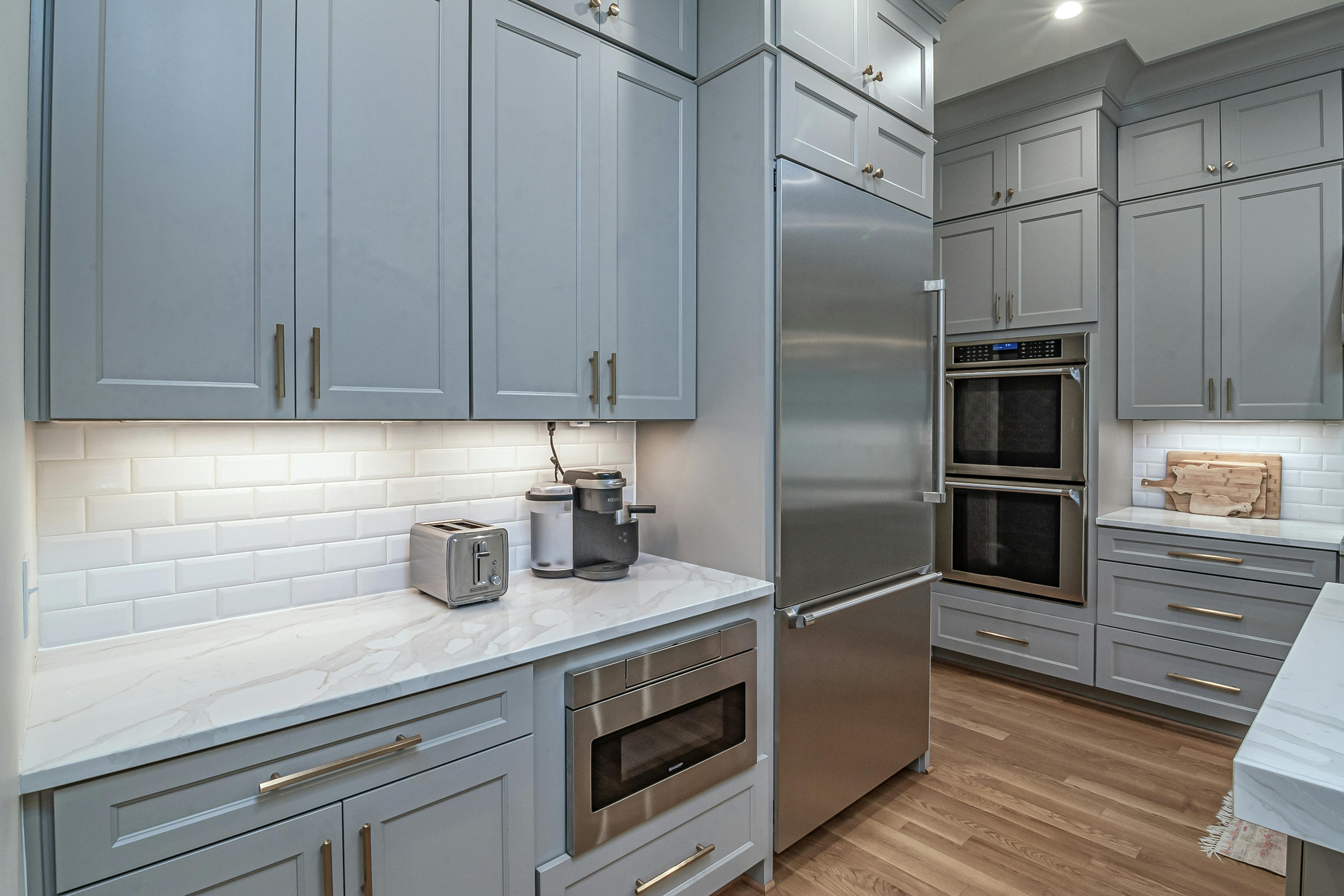 Shaker-style kitchen cabinets in a modern blue color scheme.