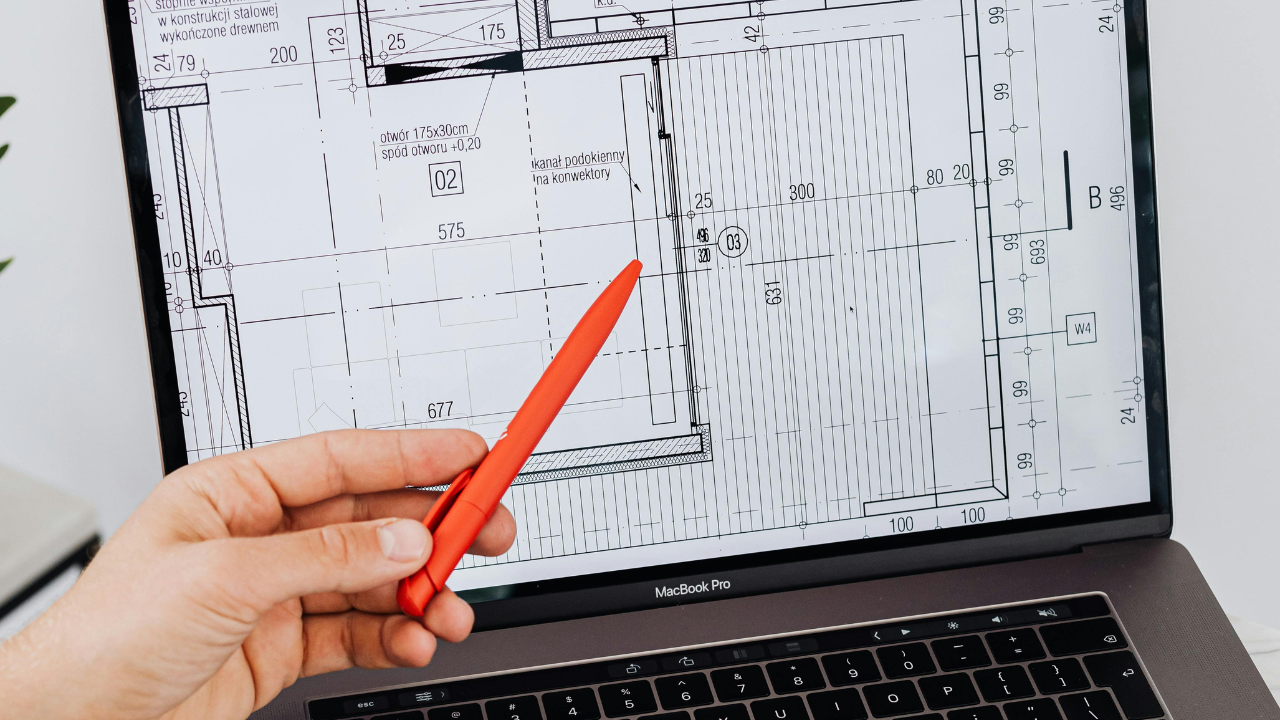 An architecture student using CAD software on a laptop to work on a digital design project.