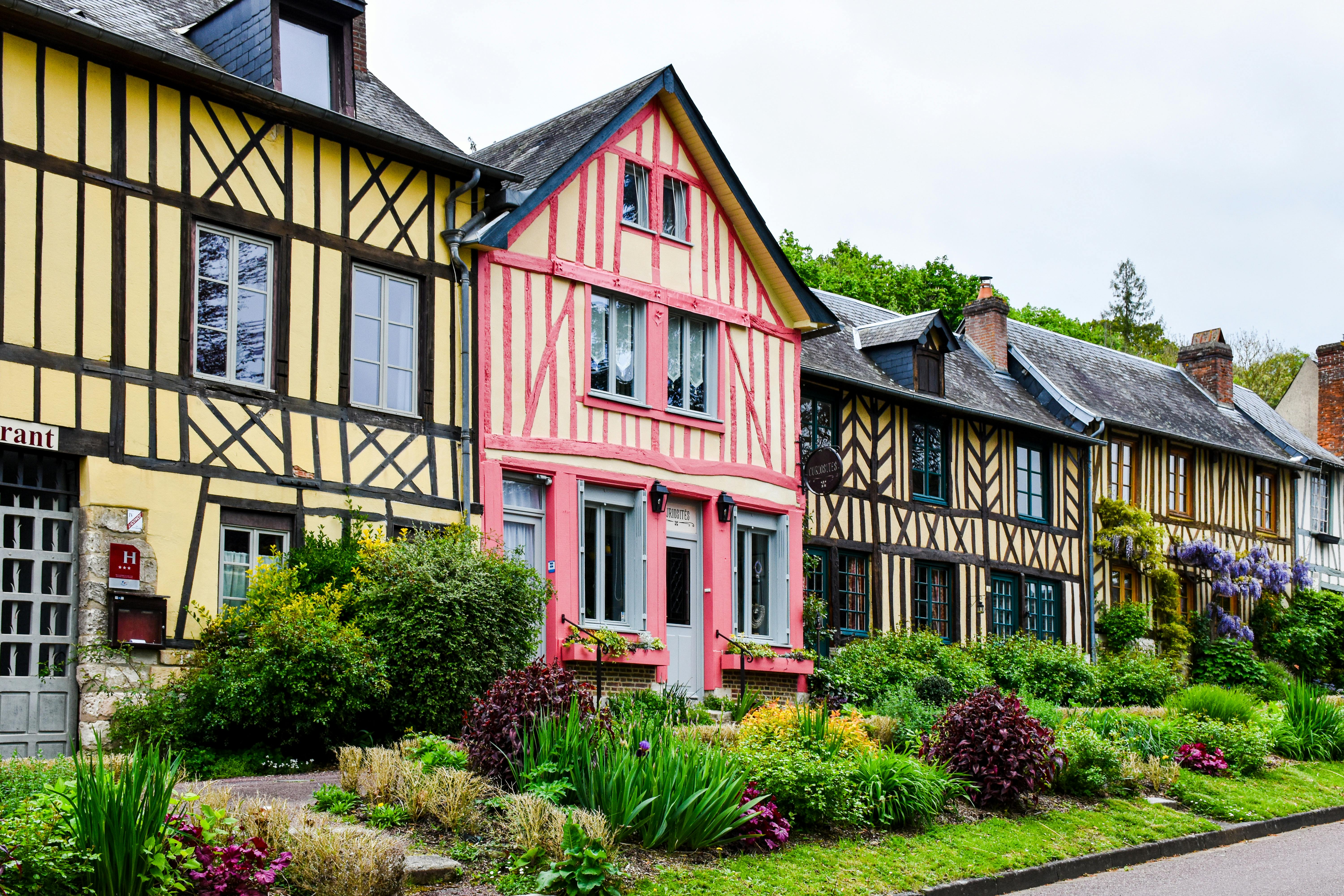 Row of colorful Tudor-style houses in France with timber detailing and vibrant facades