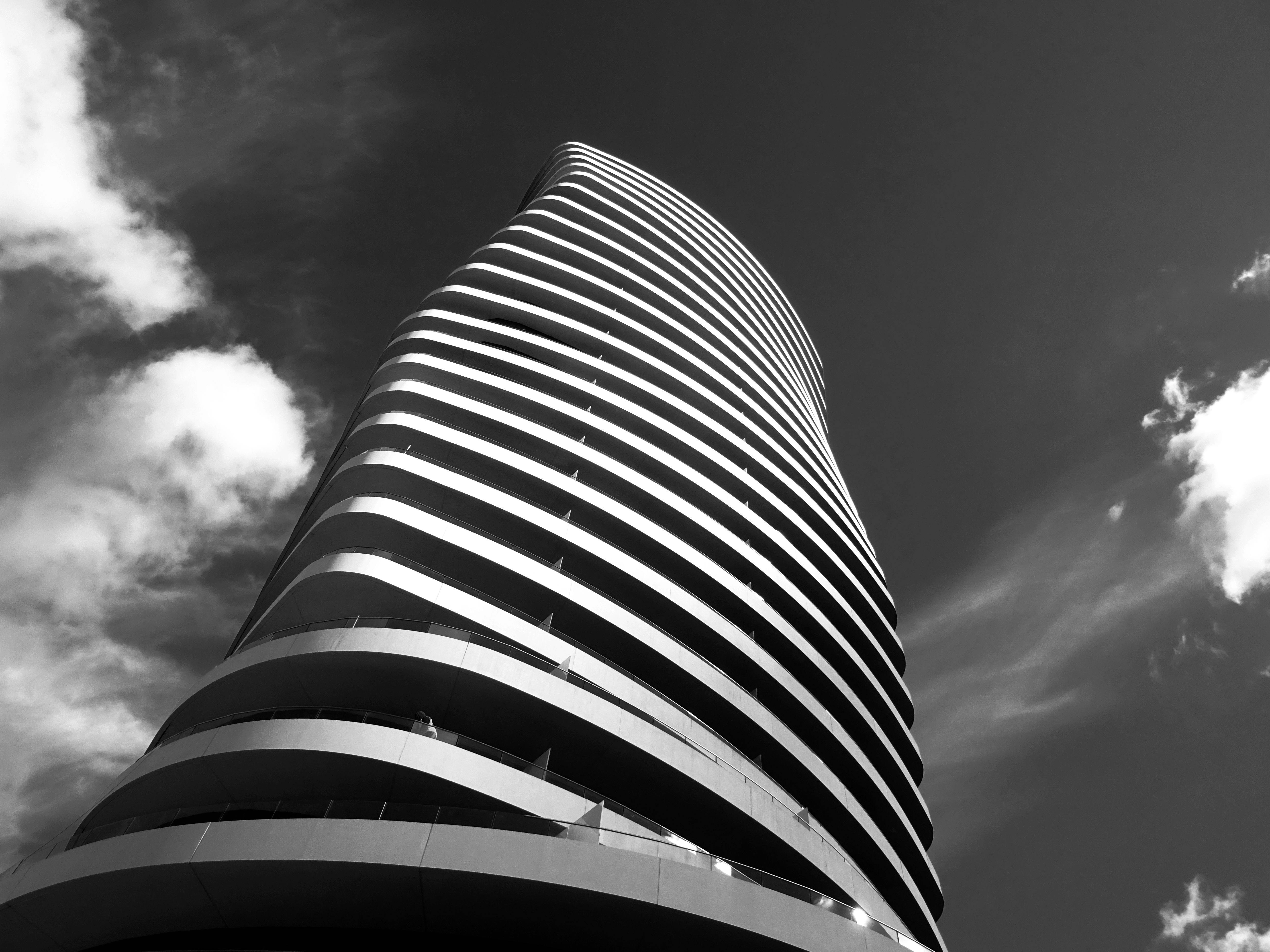 Image: A contemporary high-rise building with a glass exterior, representing modern architecture in an urban setting.