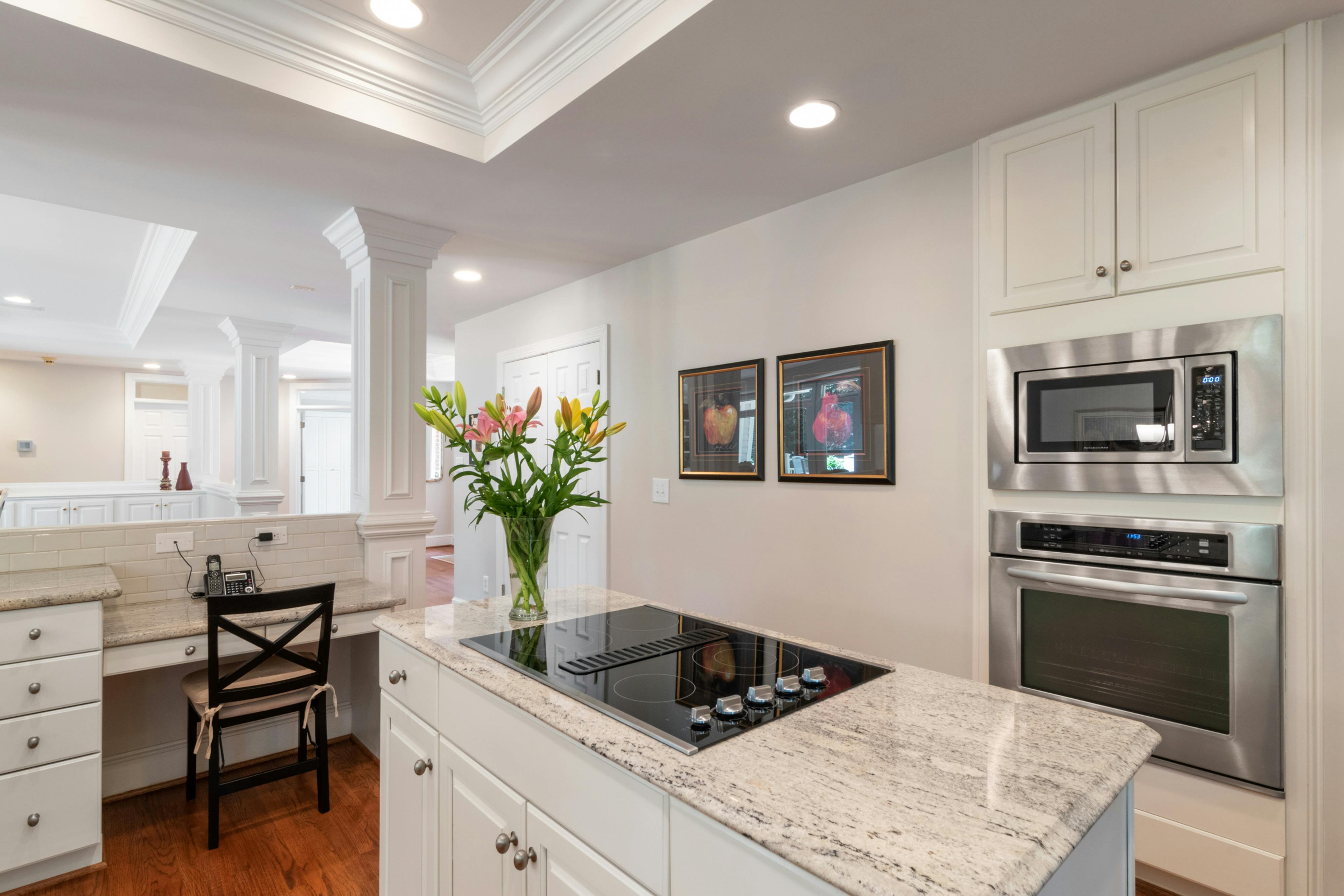 Modern kitchen with cream cabinets and light-colored walls.