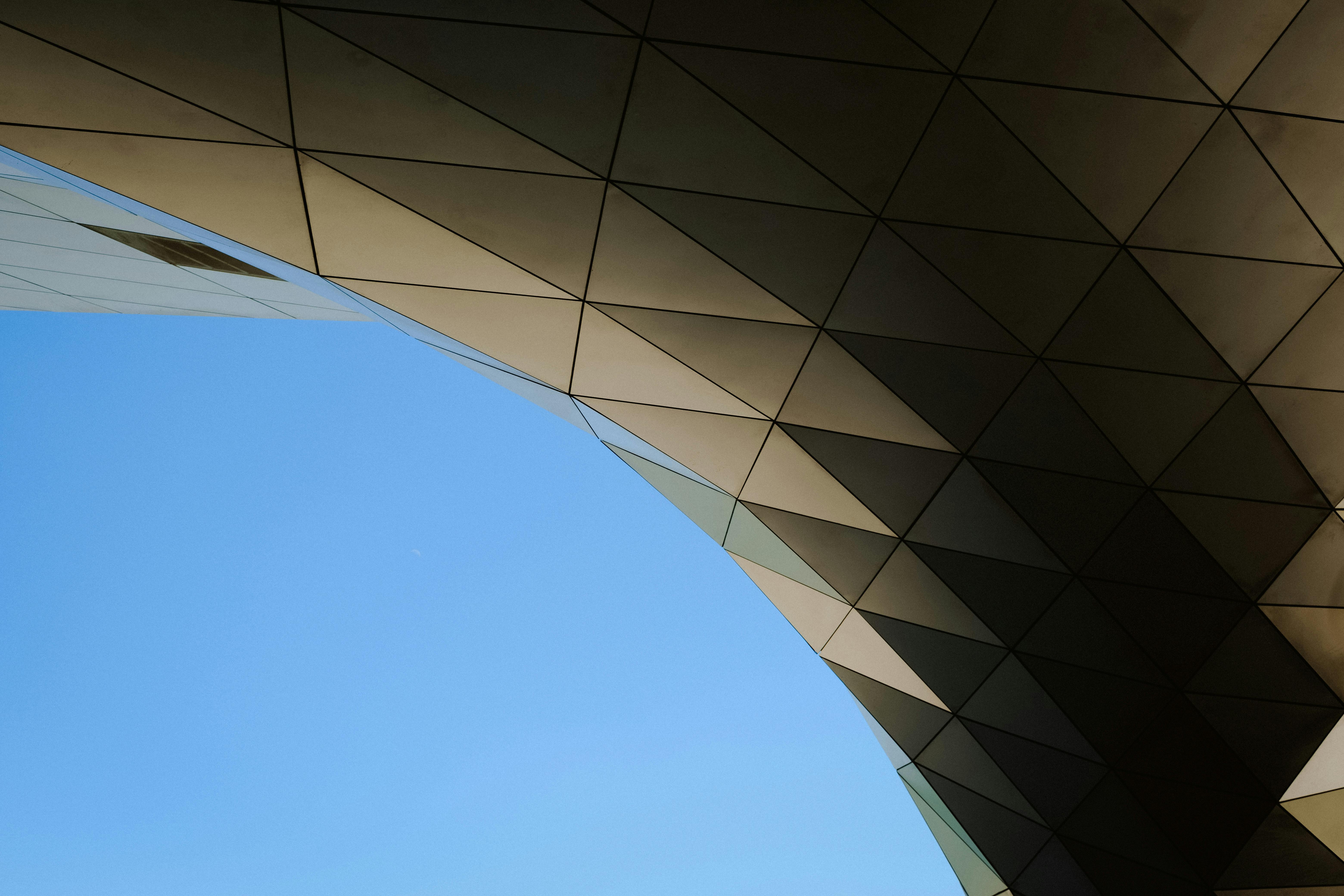 Low-angle view of a building, focusing on key design elements shaping its structure.
