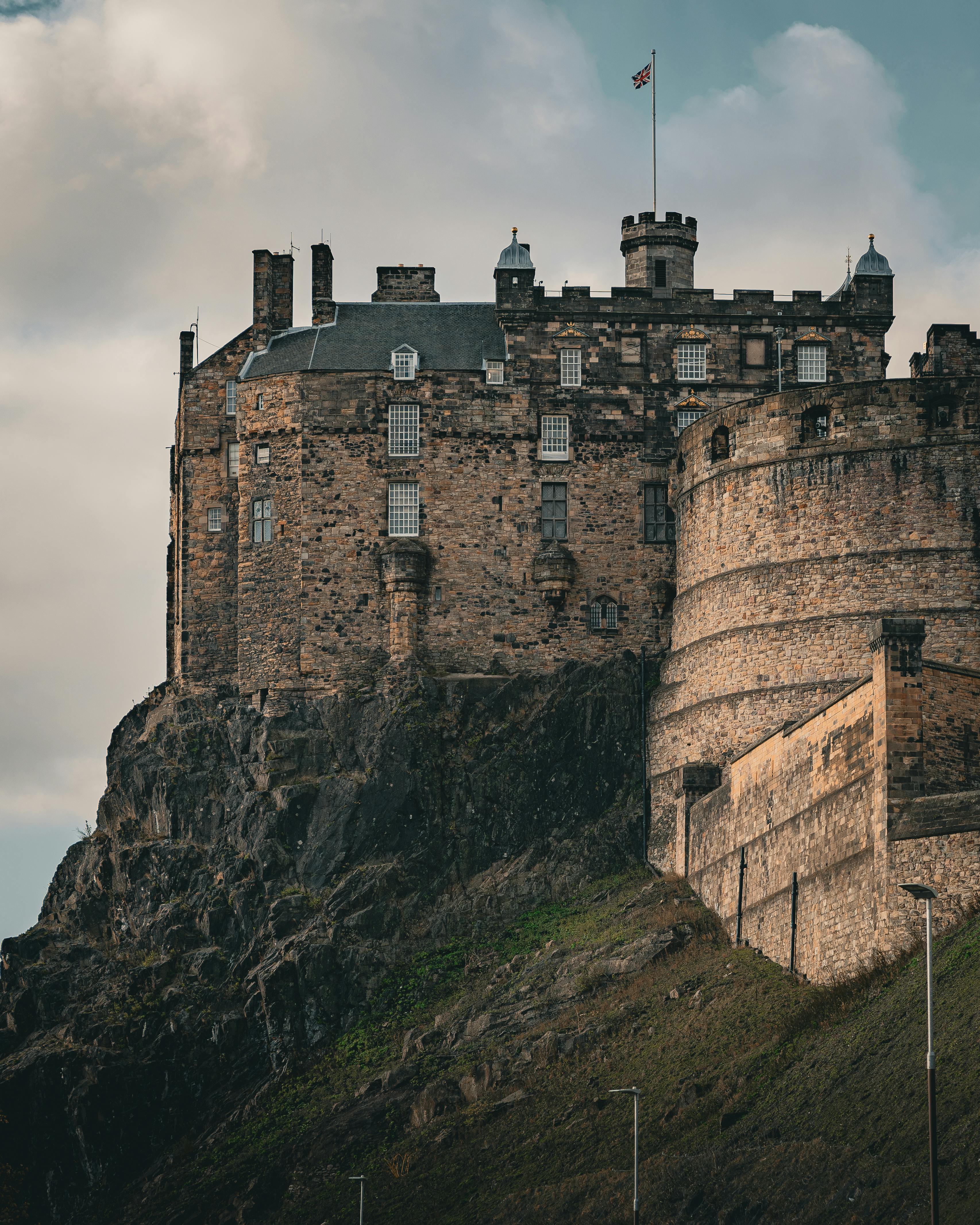 Medieval Edinburgh Castle perched on Castle Rock in Scotland, with fortified stone walls.