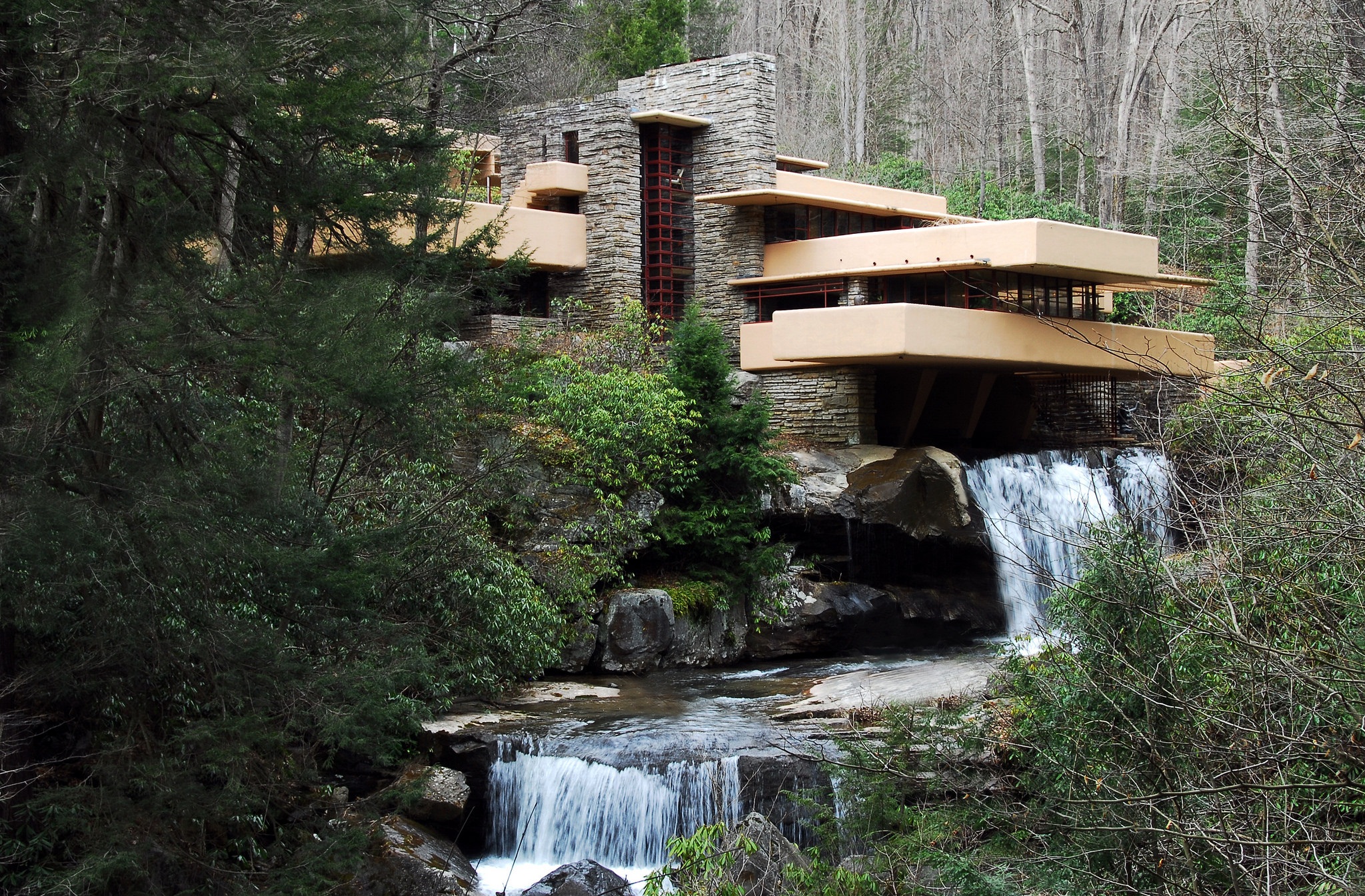 Frank Lloyd Wright’s Fallingwater house built over a stream in a forest setting.