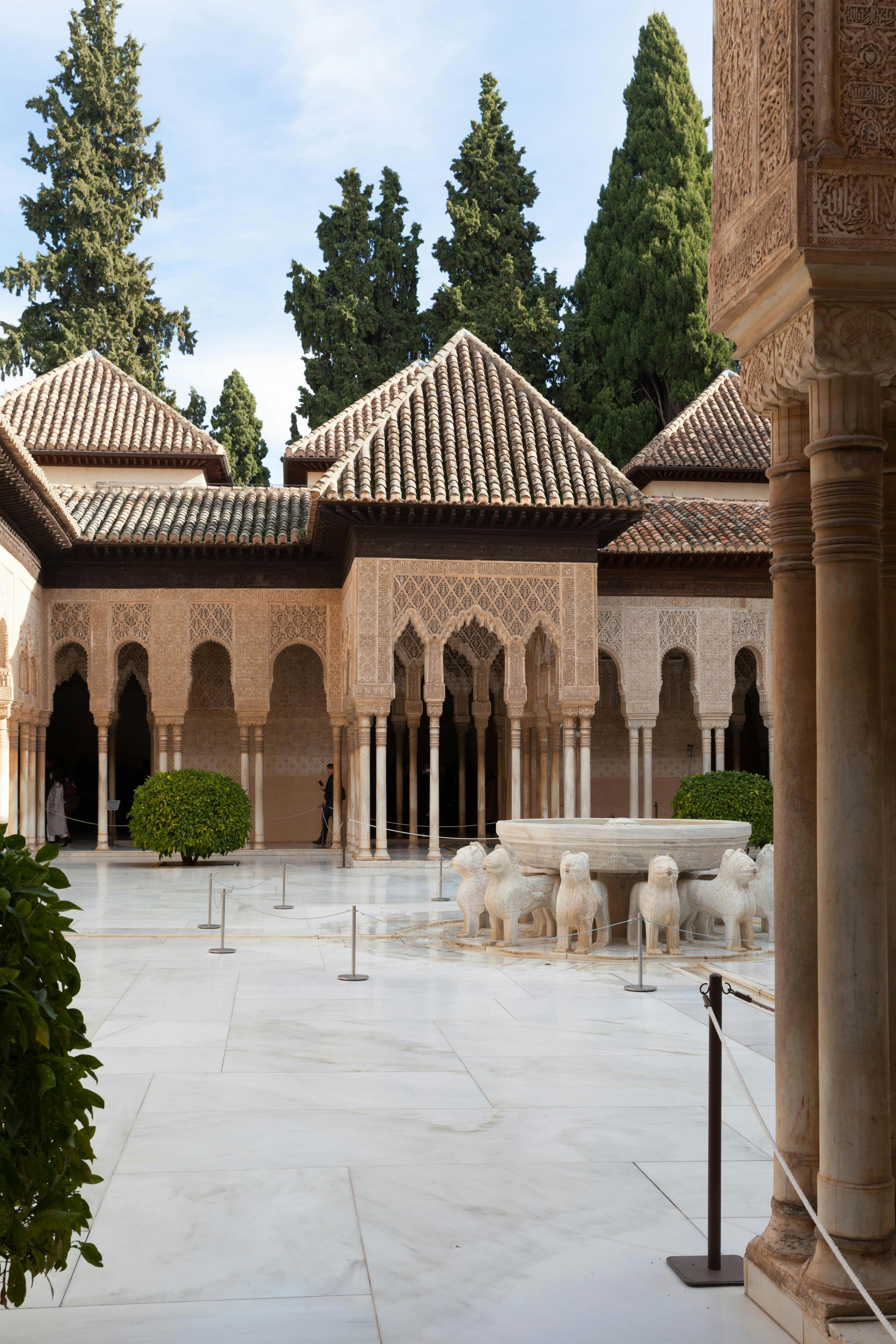 Side view of ornate Moorish arches in a medieval building in Granada, Spain, emphasizing detailed craftsmanship and eastern design influence.