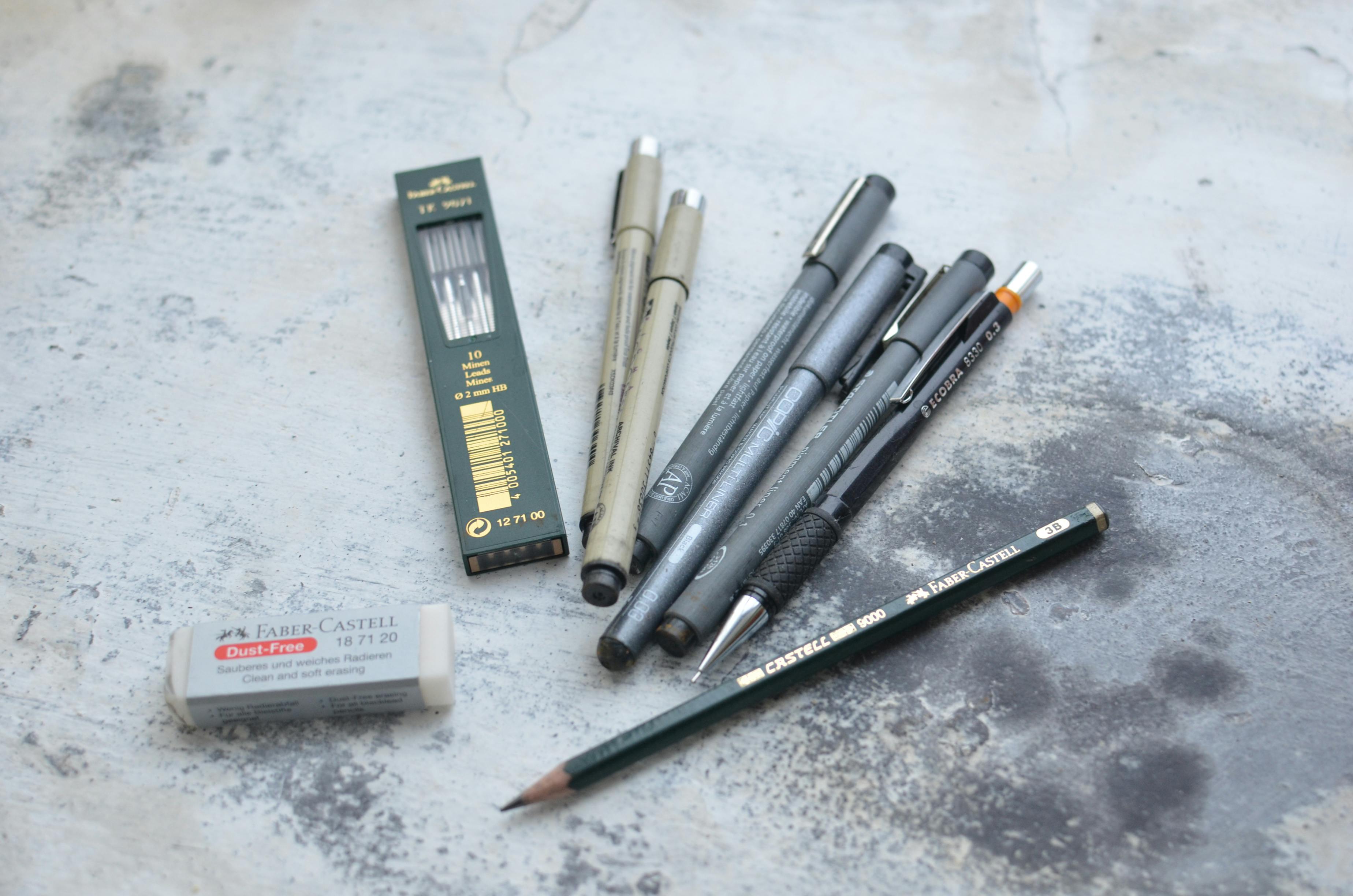 Collection of various pencils and markers used for graphic design and drawing techniques.