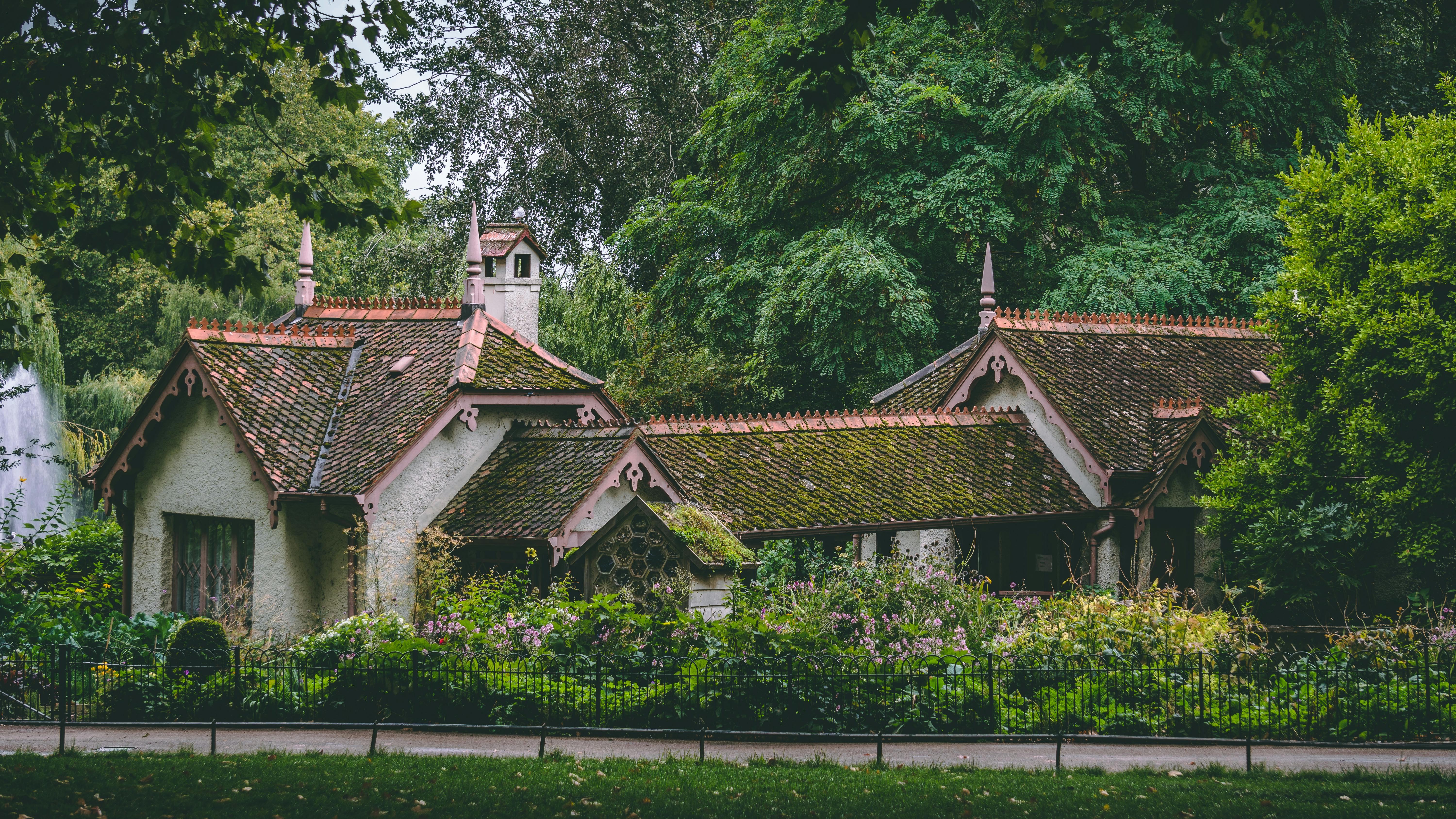 Large Indian bungalow-style house surrounded by trees, featuring a spacious layout and earthy tones.