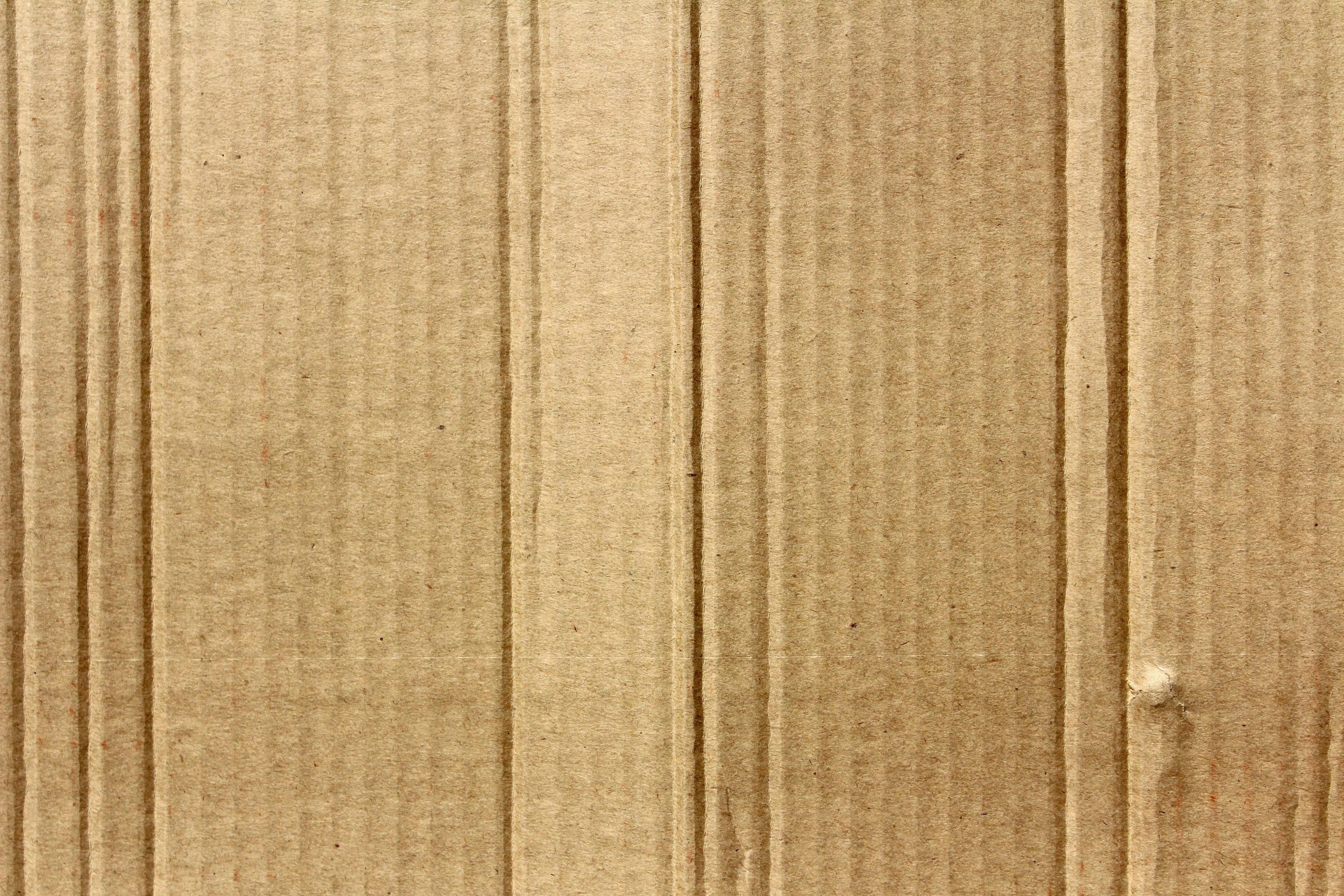 Basic brown cardboard, shown as an ineffective material for insulation due to its low thermal resistance.