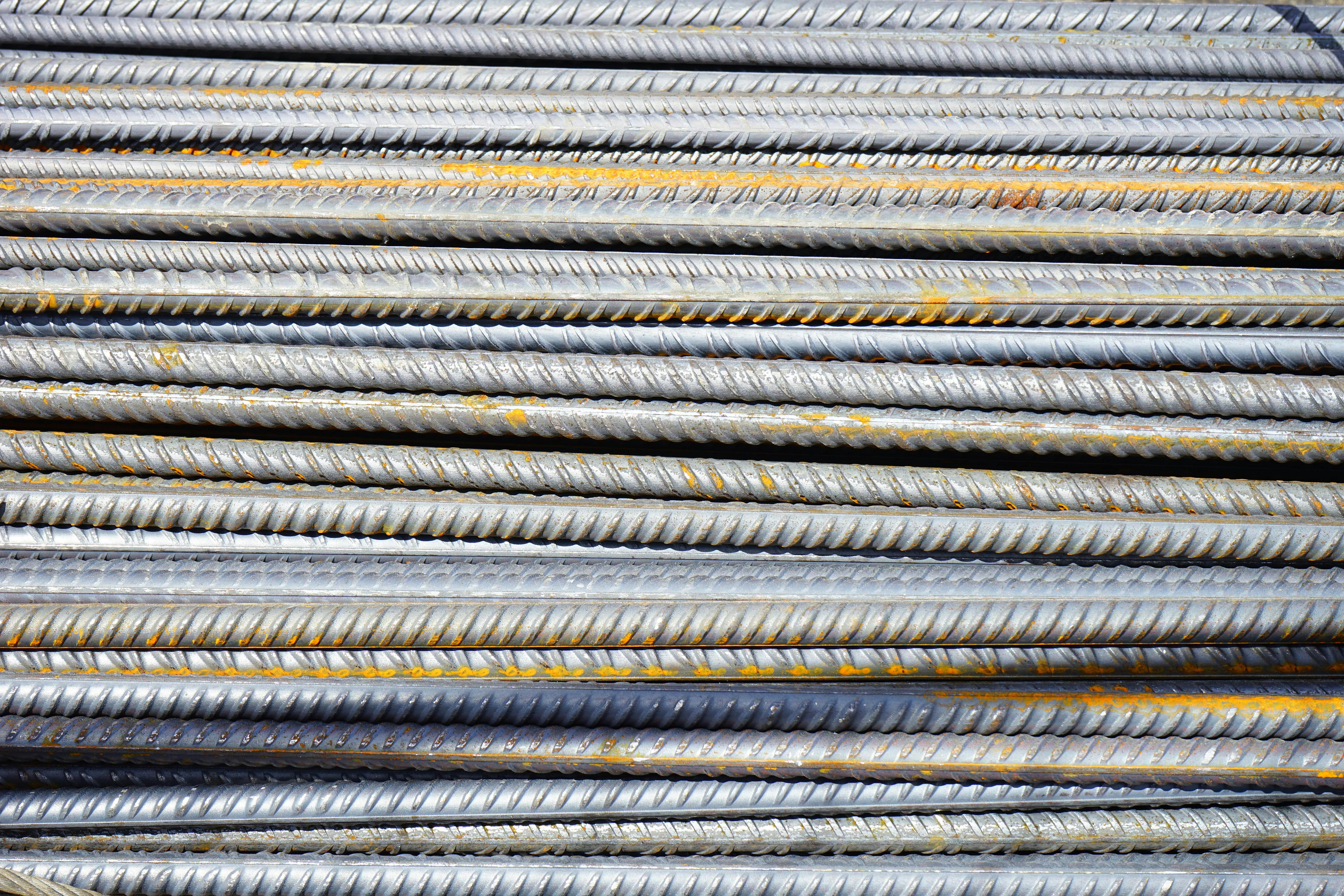 Steel rods bundled at a construction site, ready for use in reinforced concrete structures.
