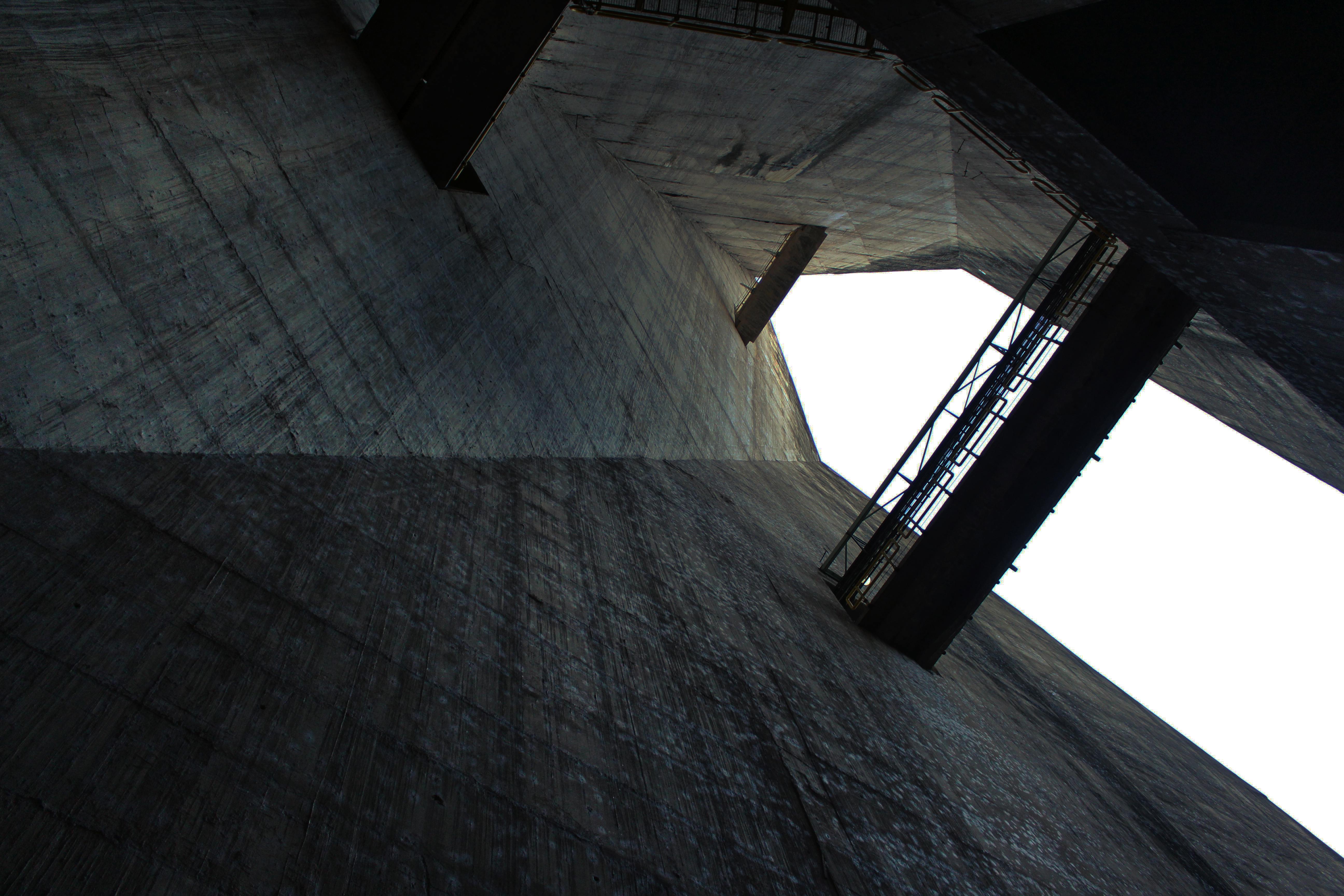 Low angle view of an unfinished concrete structure showing columns and beams.