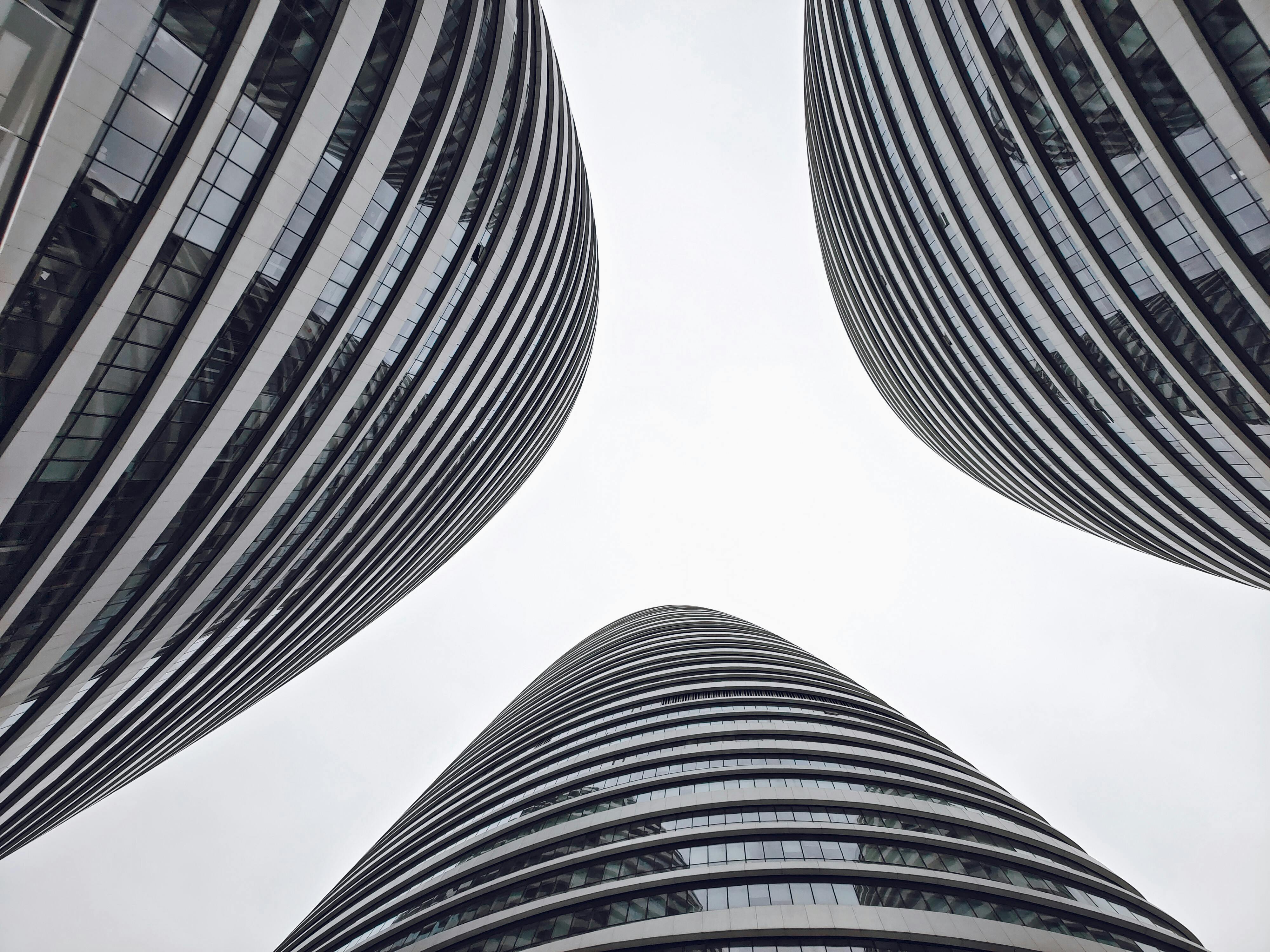A low-angle shot of high-rise buildings in Chaoyang, Beijing, showcasing modern and contemporary architectural styles with sleek, glass facades.