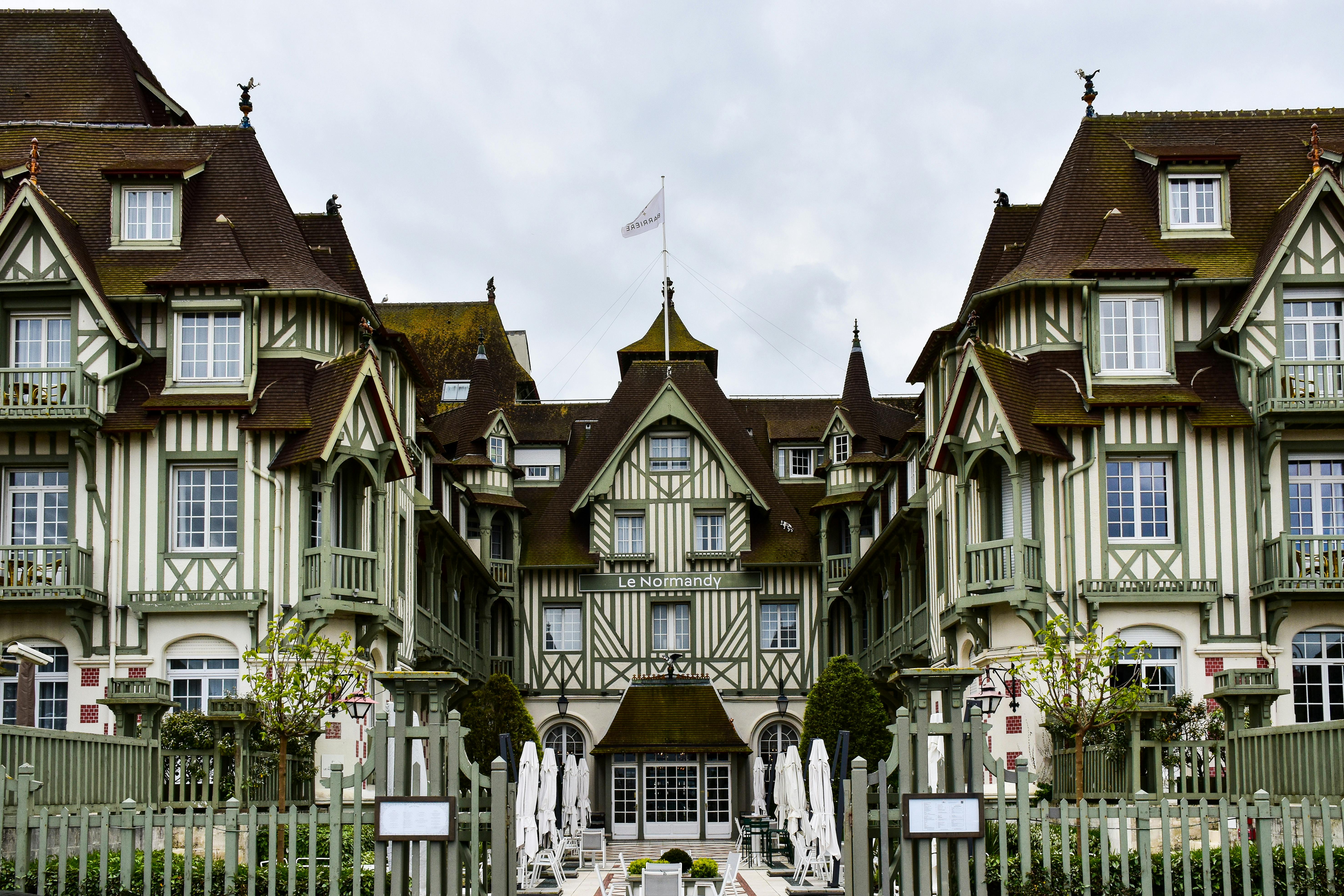 Large Tudor-style house in Deauville, France with prominent cross gables and detailed timber framing.