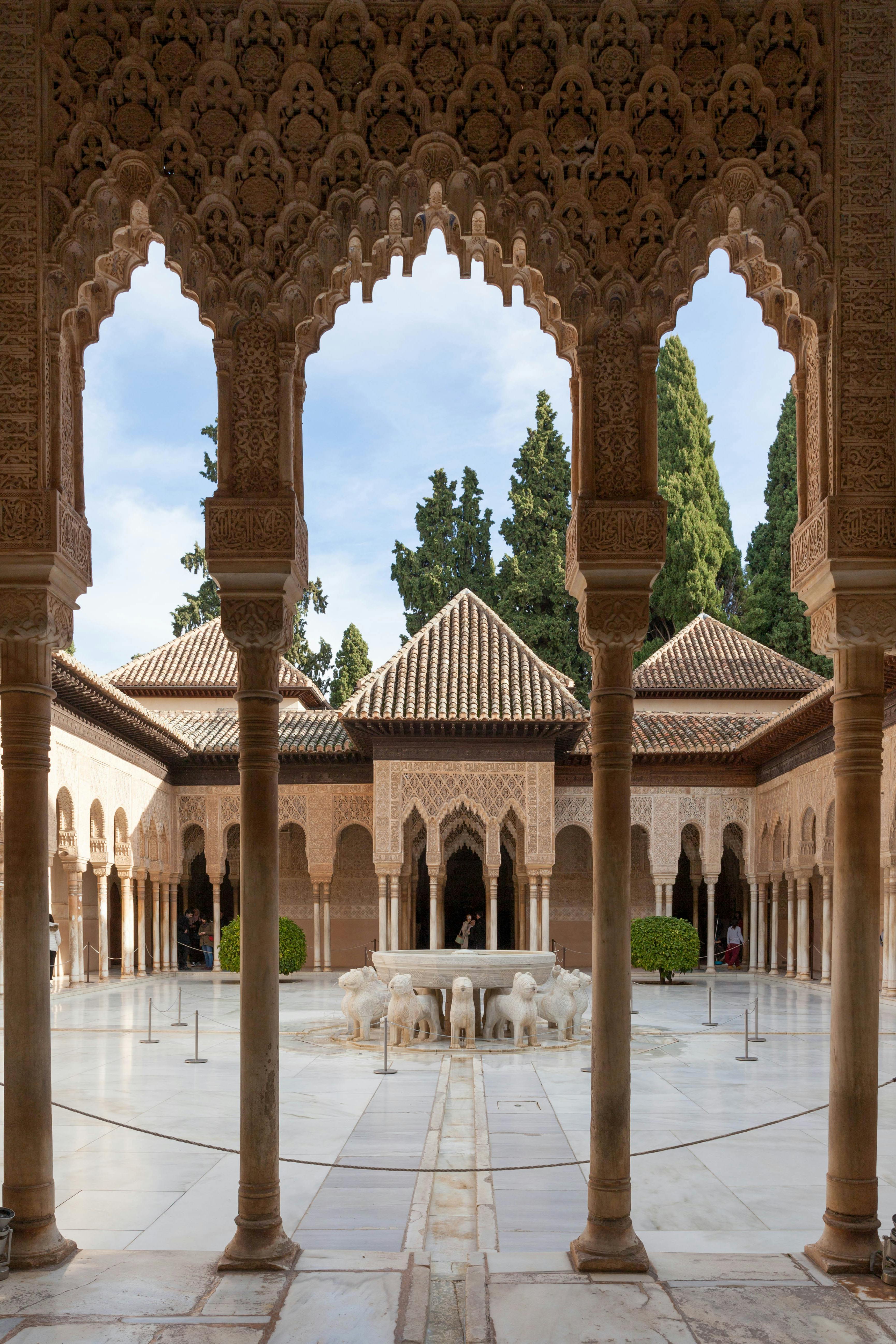 Ornate arches in a Moorish-style building in Granada, Spain, showcasing eastern architectural influence from the medieval period.