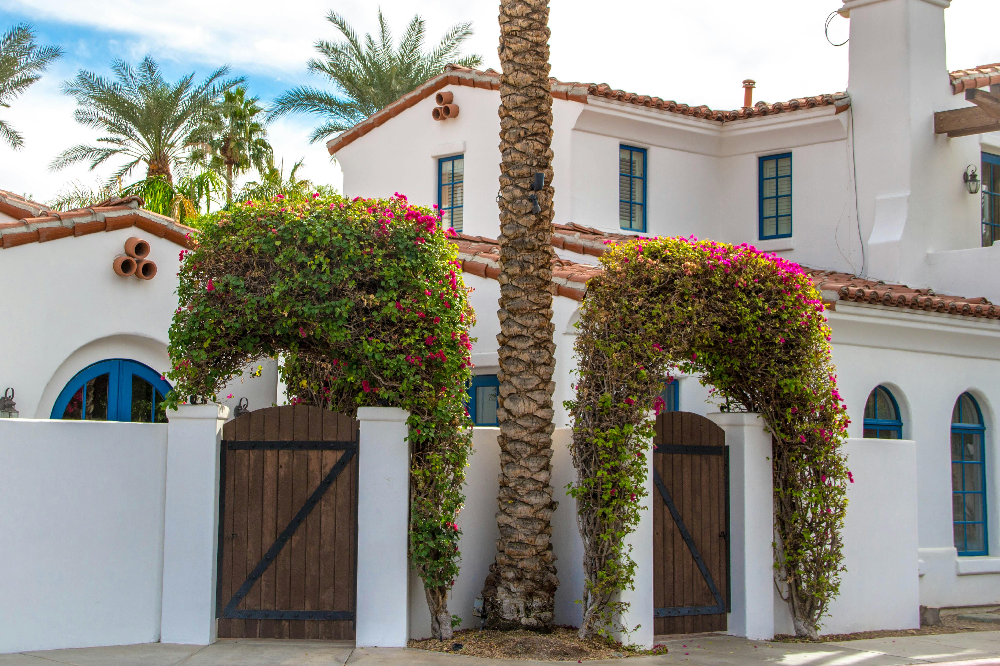 Mediterranean-style house in La Quinta with white walls and brown architectural accents.