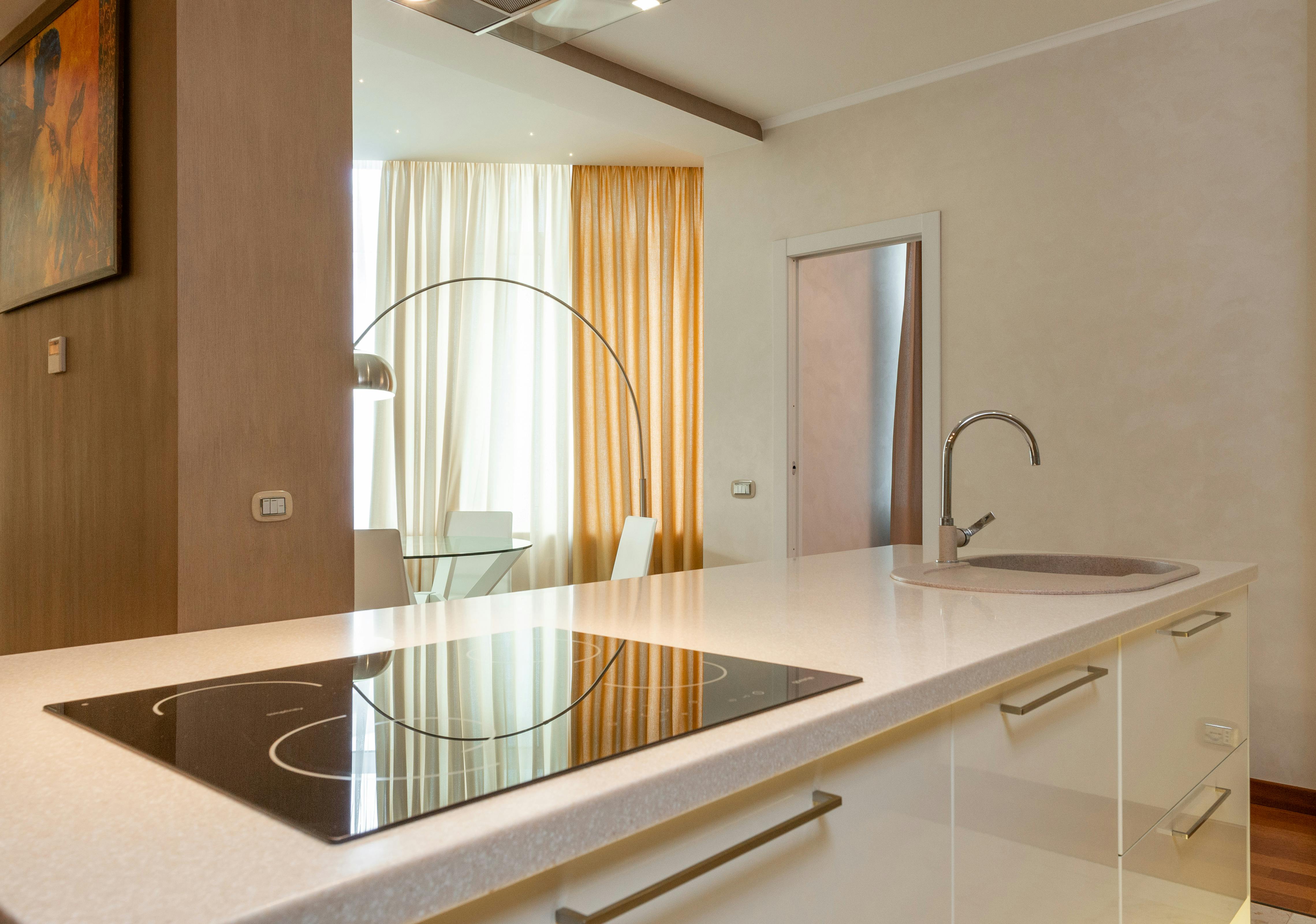 Contemporary cream kitchen island with a built-in stove and sink, designed for functionality and style.