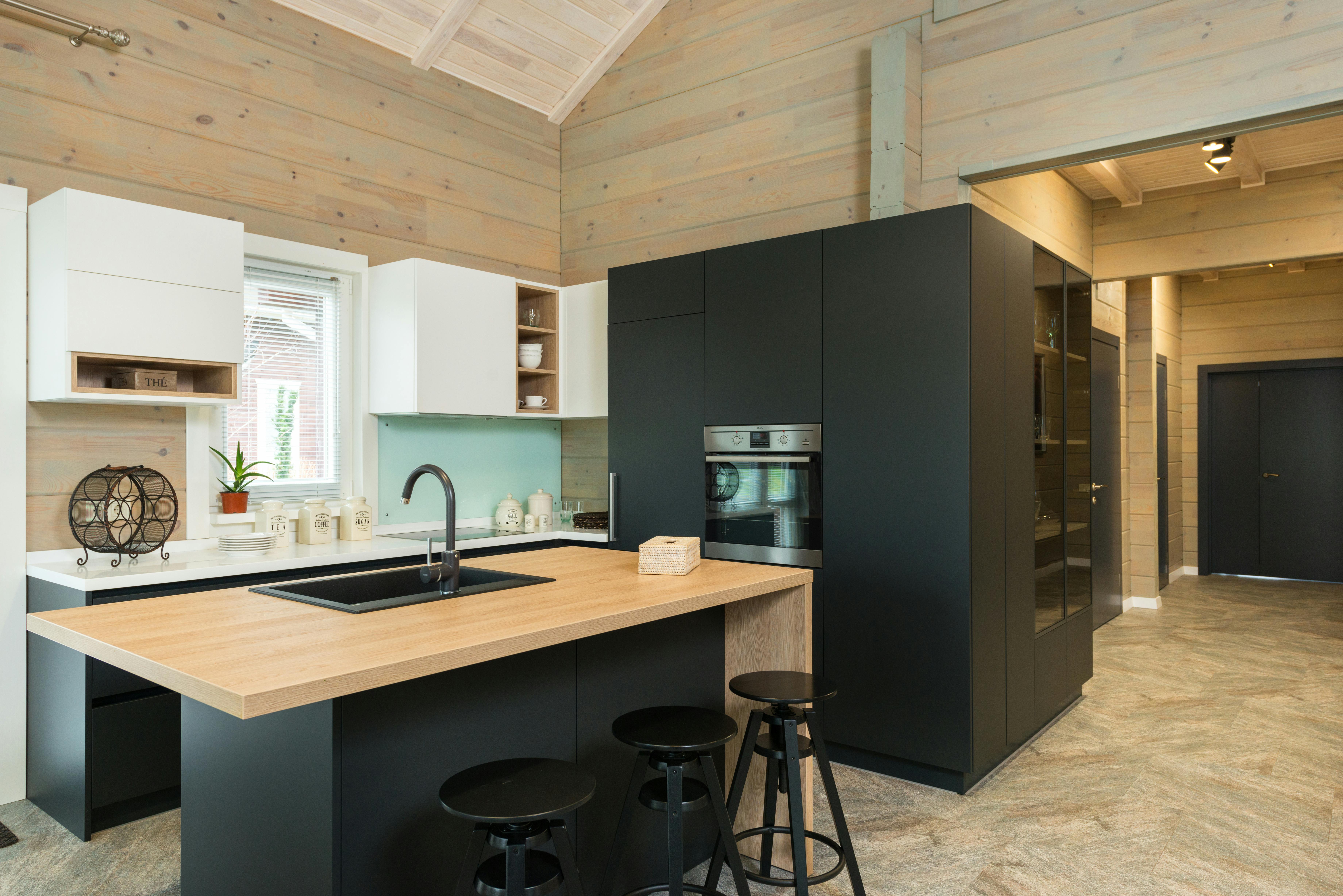 Modern kitchen with wood furniture and open living space, combining classic design with contemporary features.