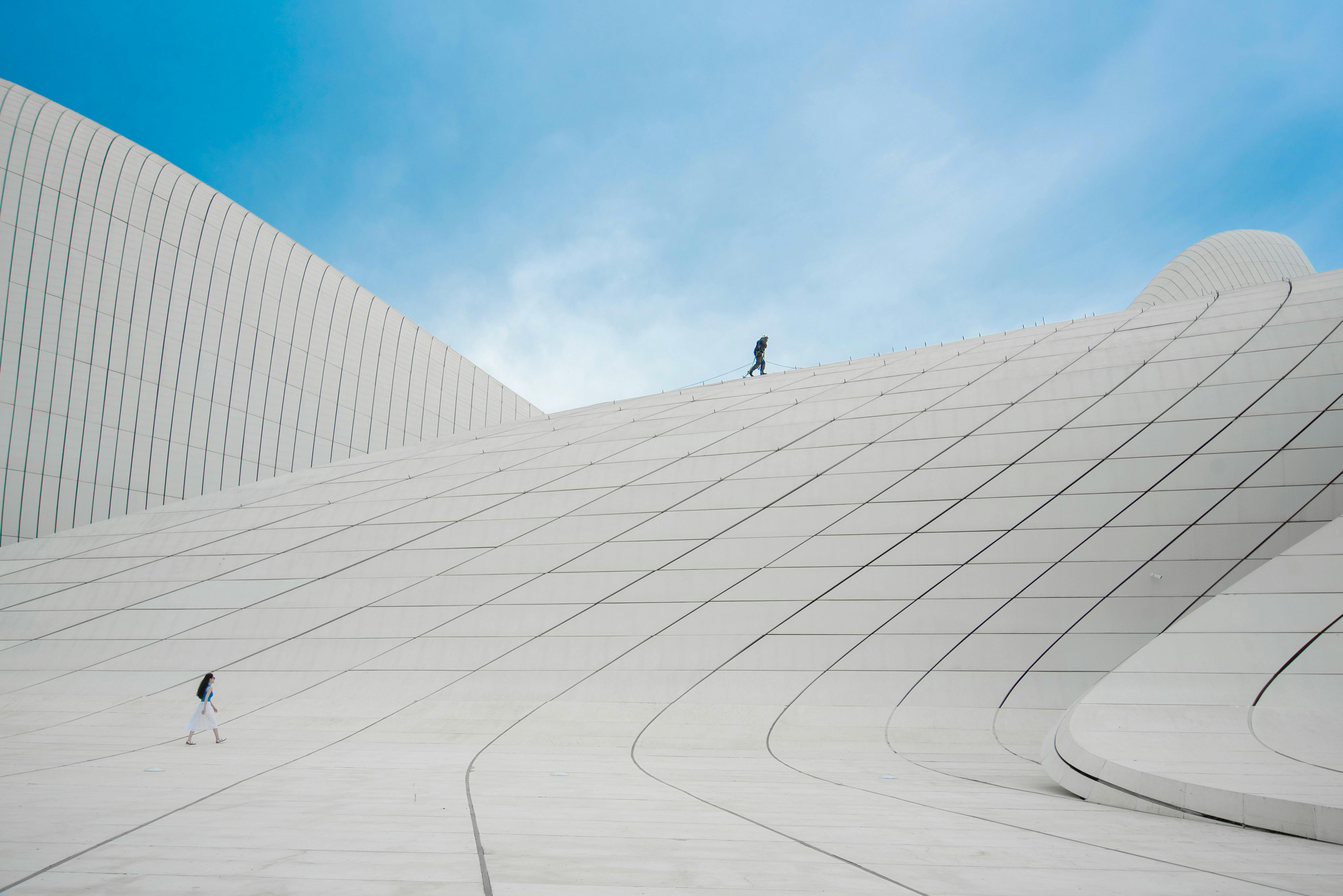 Minimalist architectural structure with massive scale, making people appear tiny in comparison.