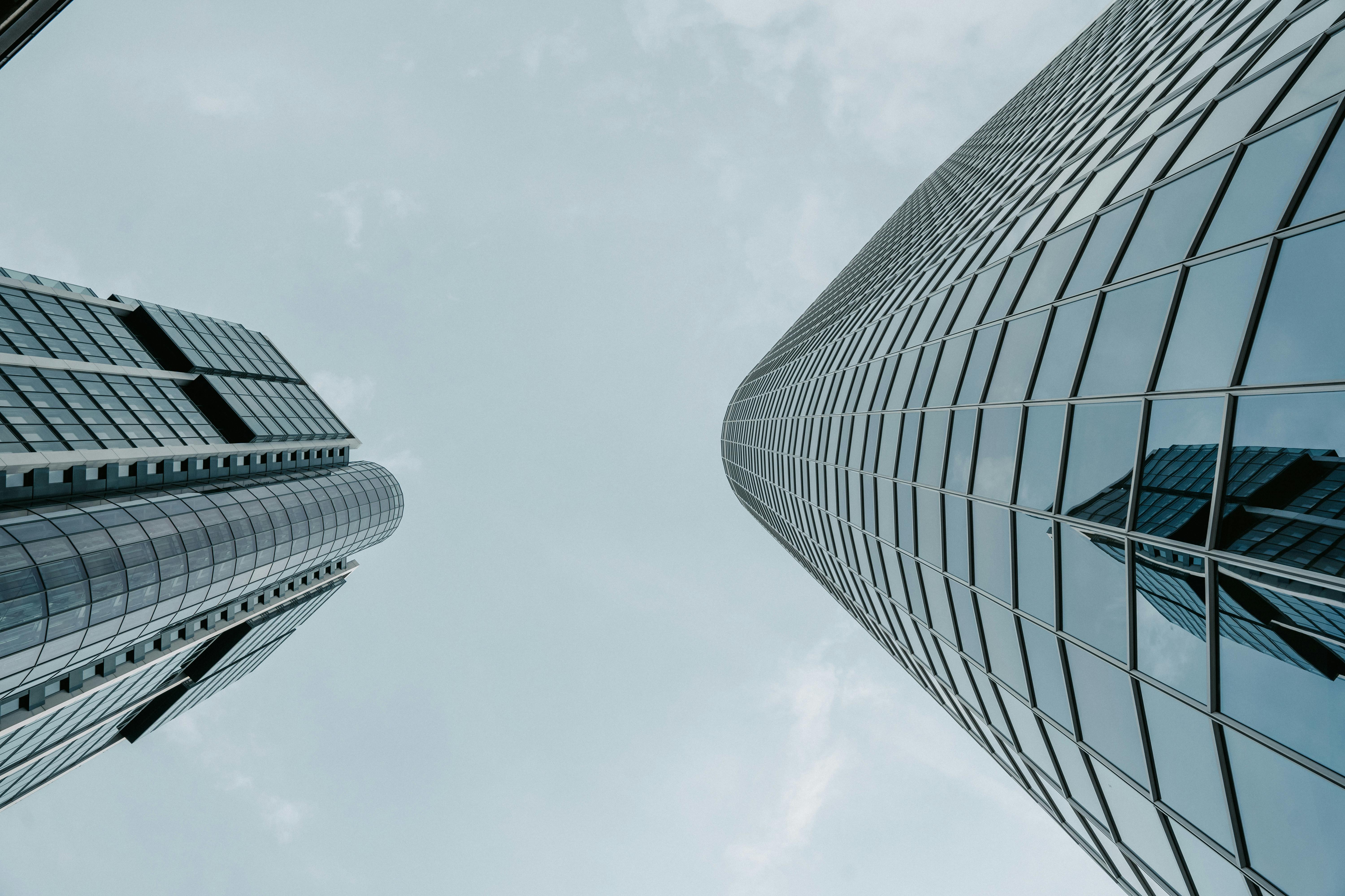 Glass windows of a modern skyscraper reflecting the sky.