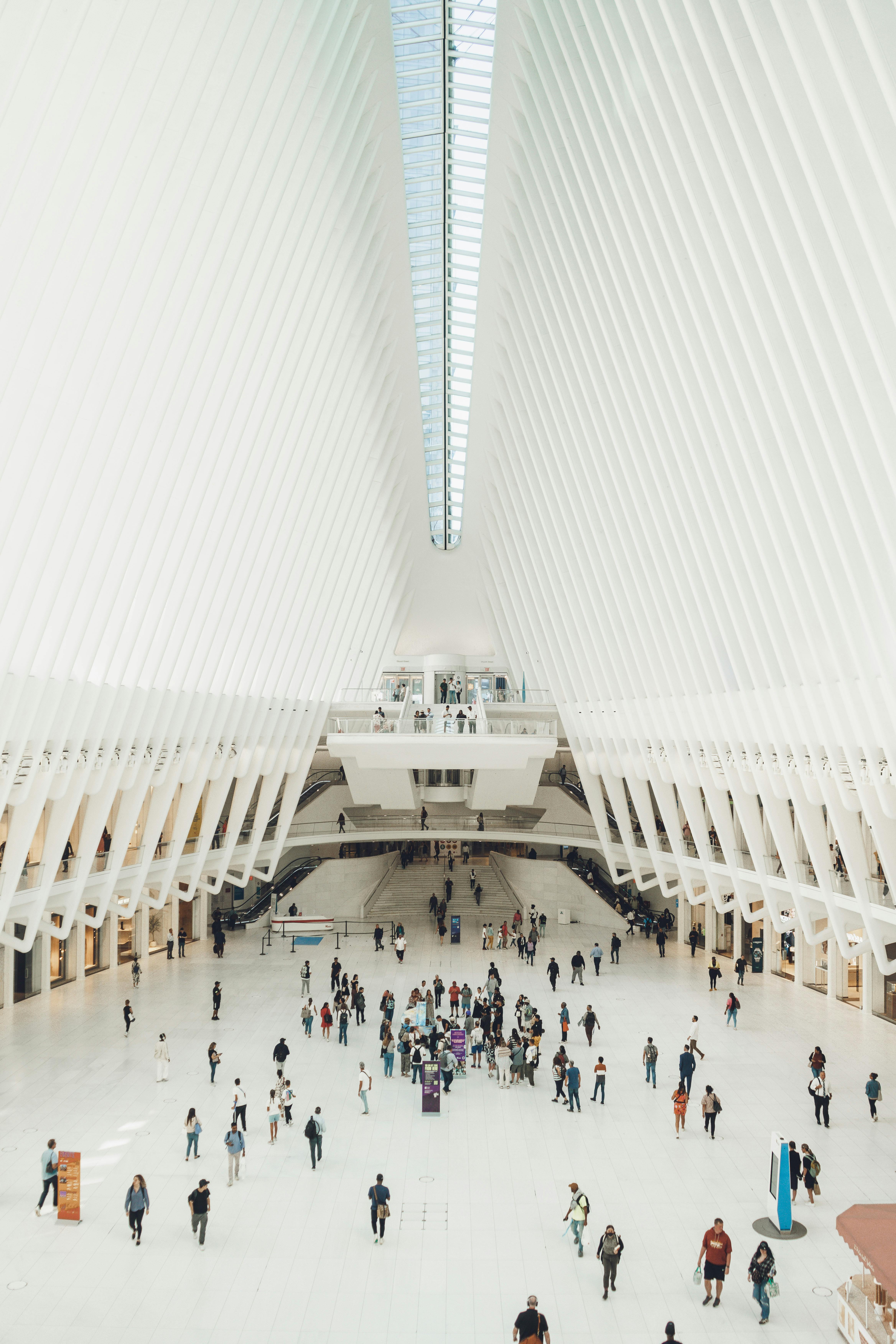 Interior of the Oculus in New York, showcasing its striking organic and curved architectural form with visitors.