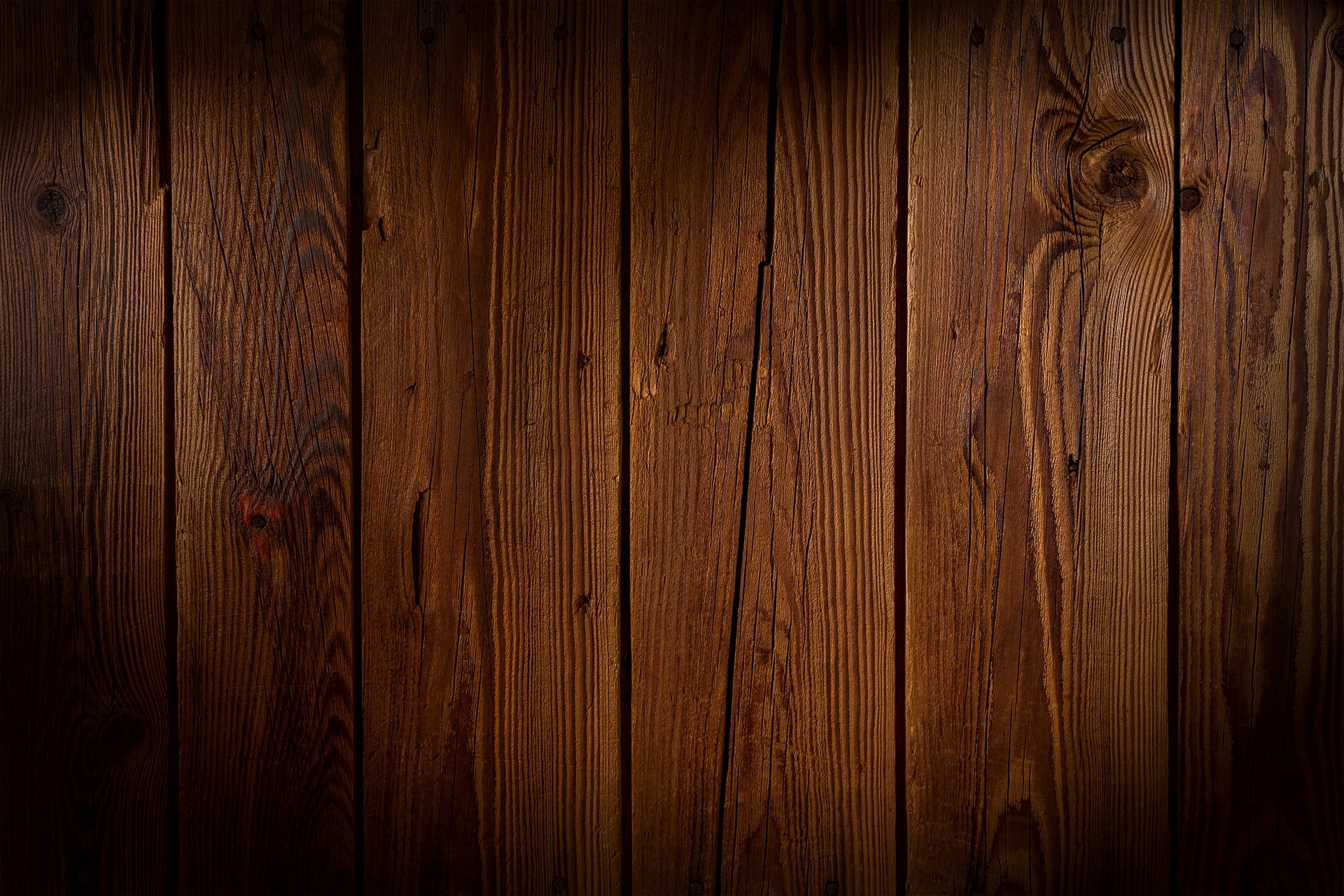 Close-up of a rich, detailed wood surface showing grain patterns and texture.