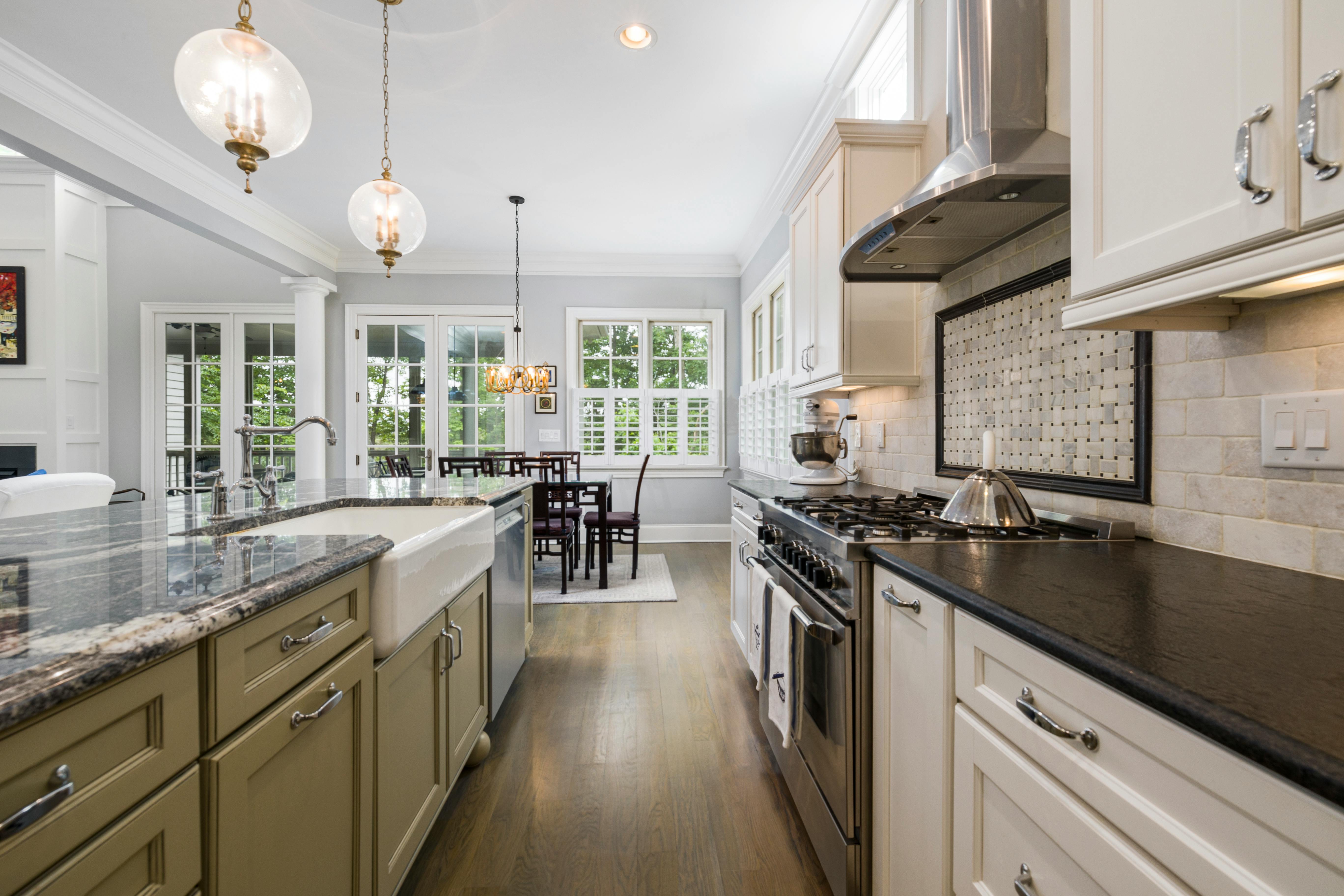 Spacious contemporary kitchen with cream Shaker-style cabinets and modern appliances.
