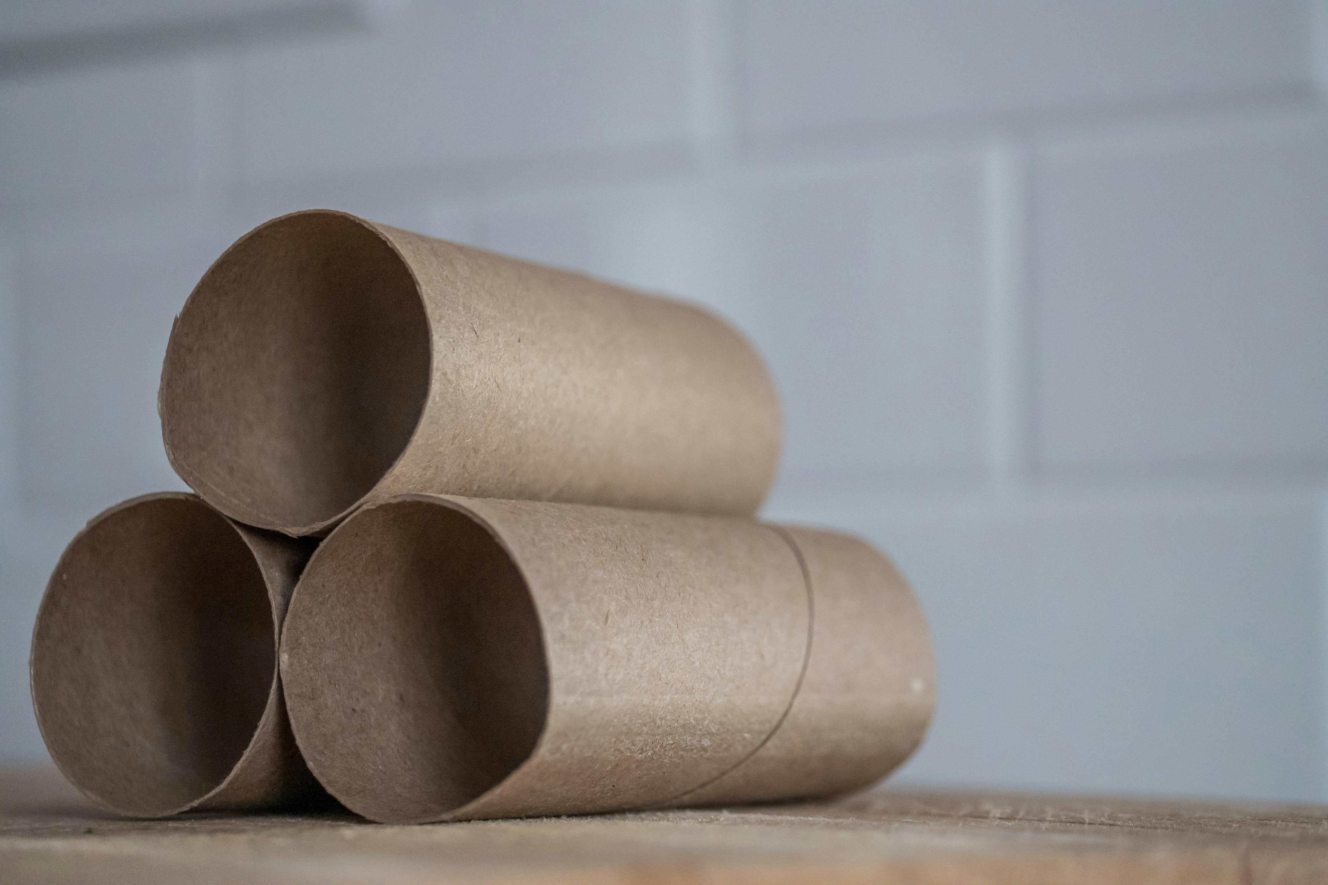 Stack of cardboard rolls on a table.