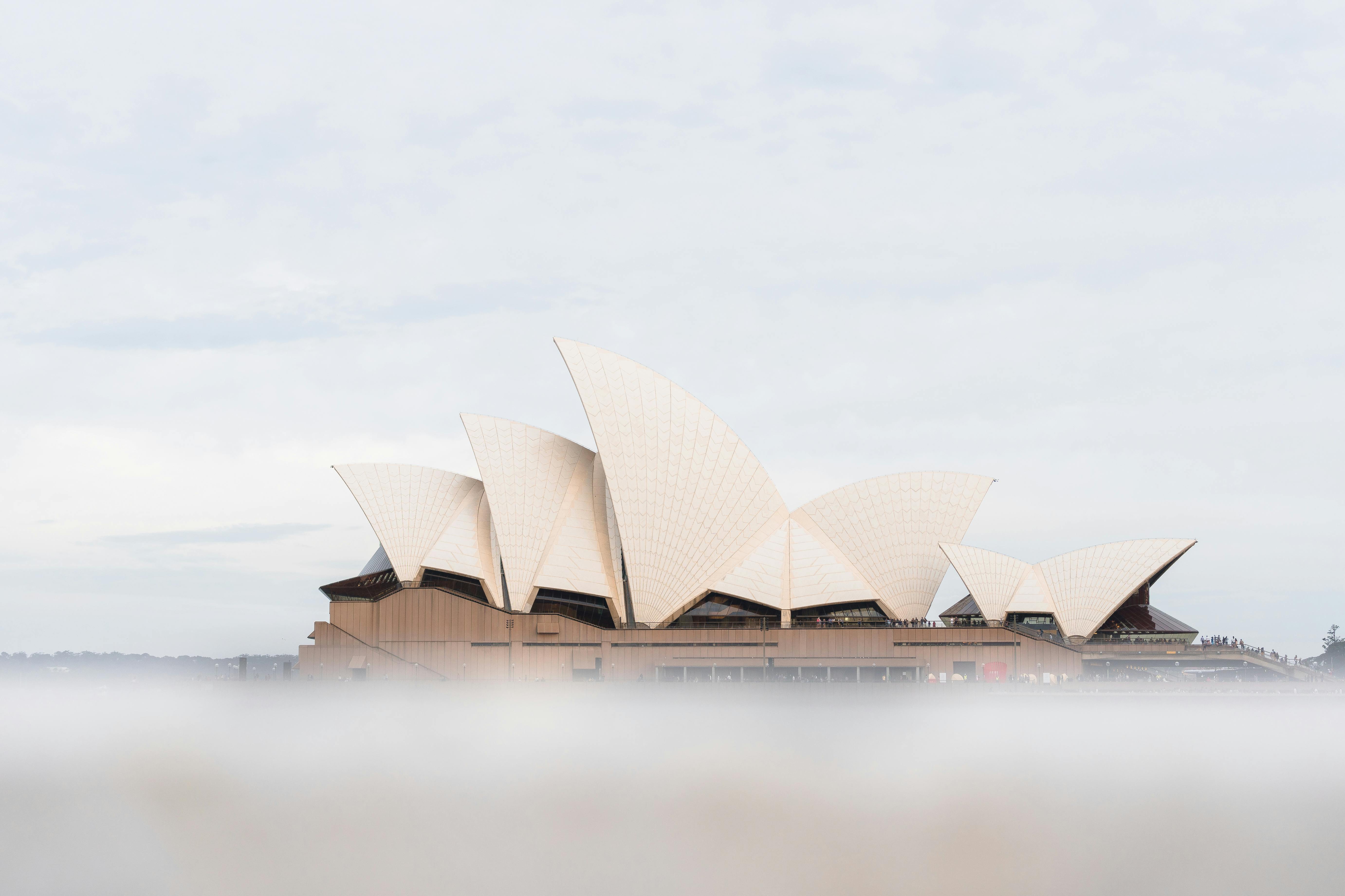 Sydney Opera House with its iconic shell-like roof structure on the waterfront.
