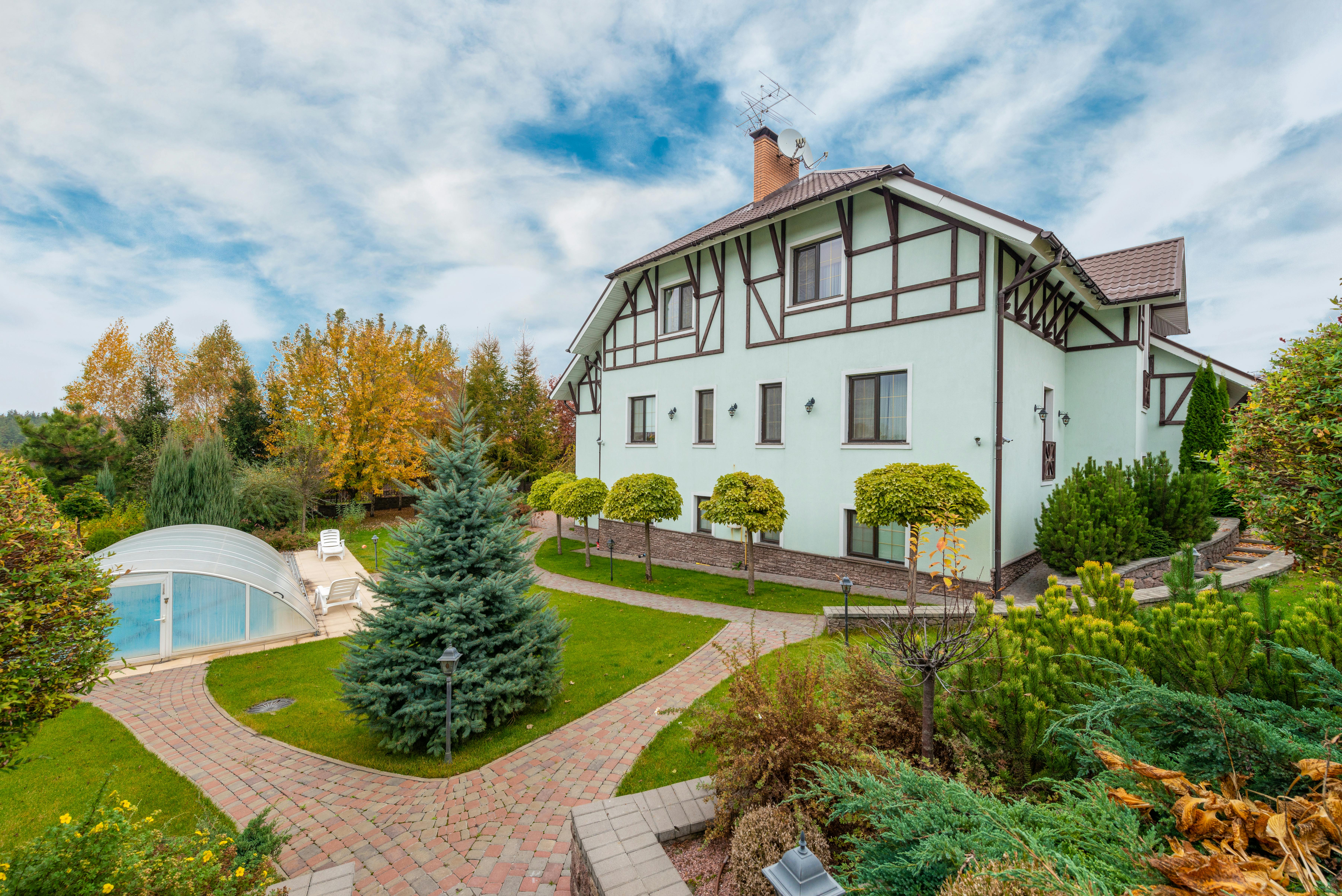 Tudor-style house with manicured garden and timber detailing