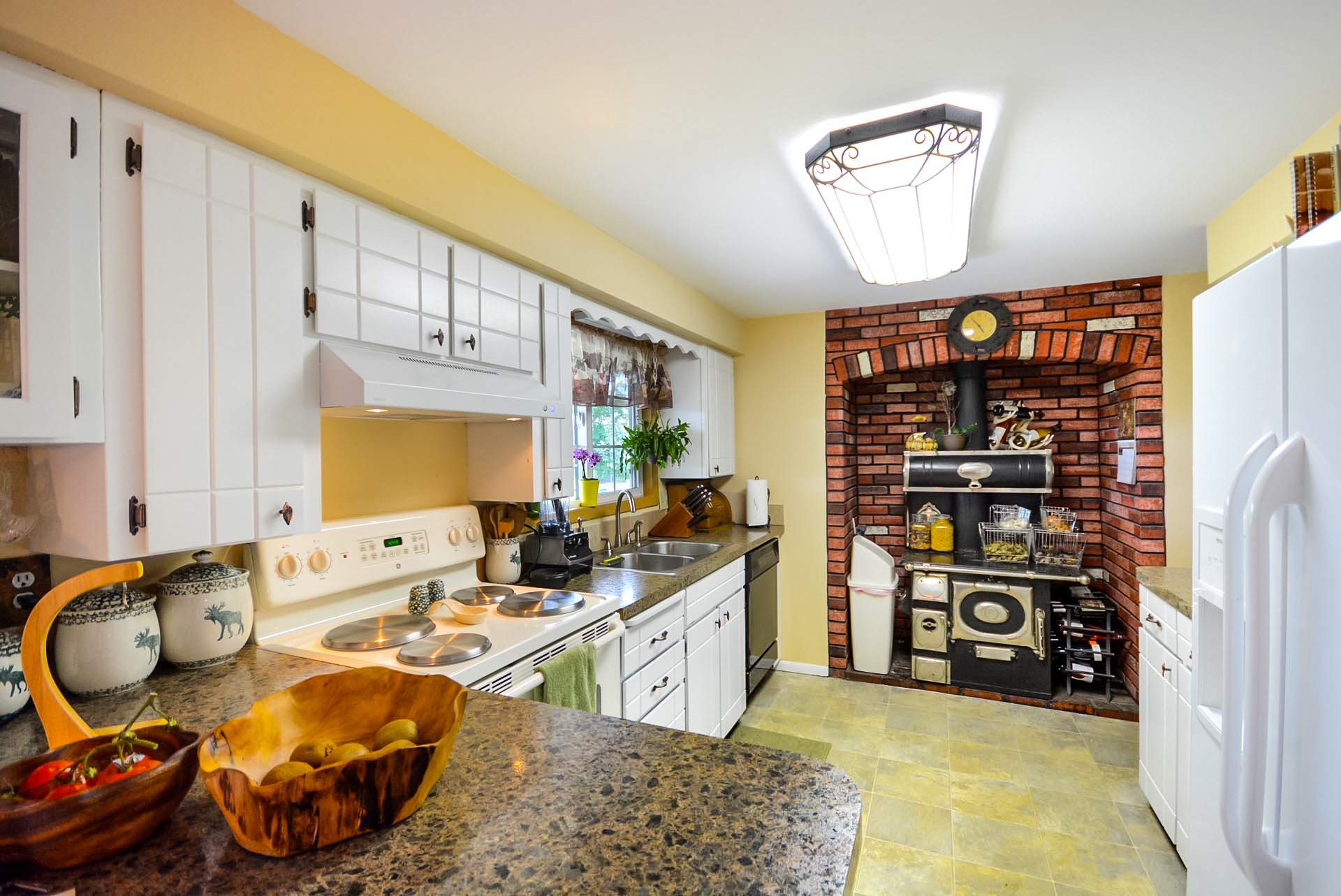 Vintage kitchen with antique cream cabinets, offering a classic, timeless aesthetic.