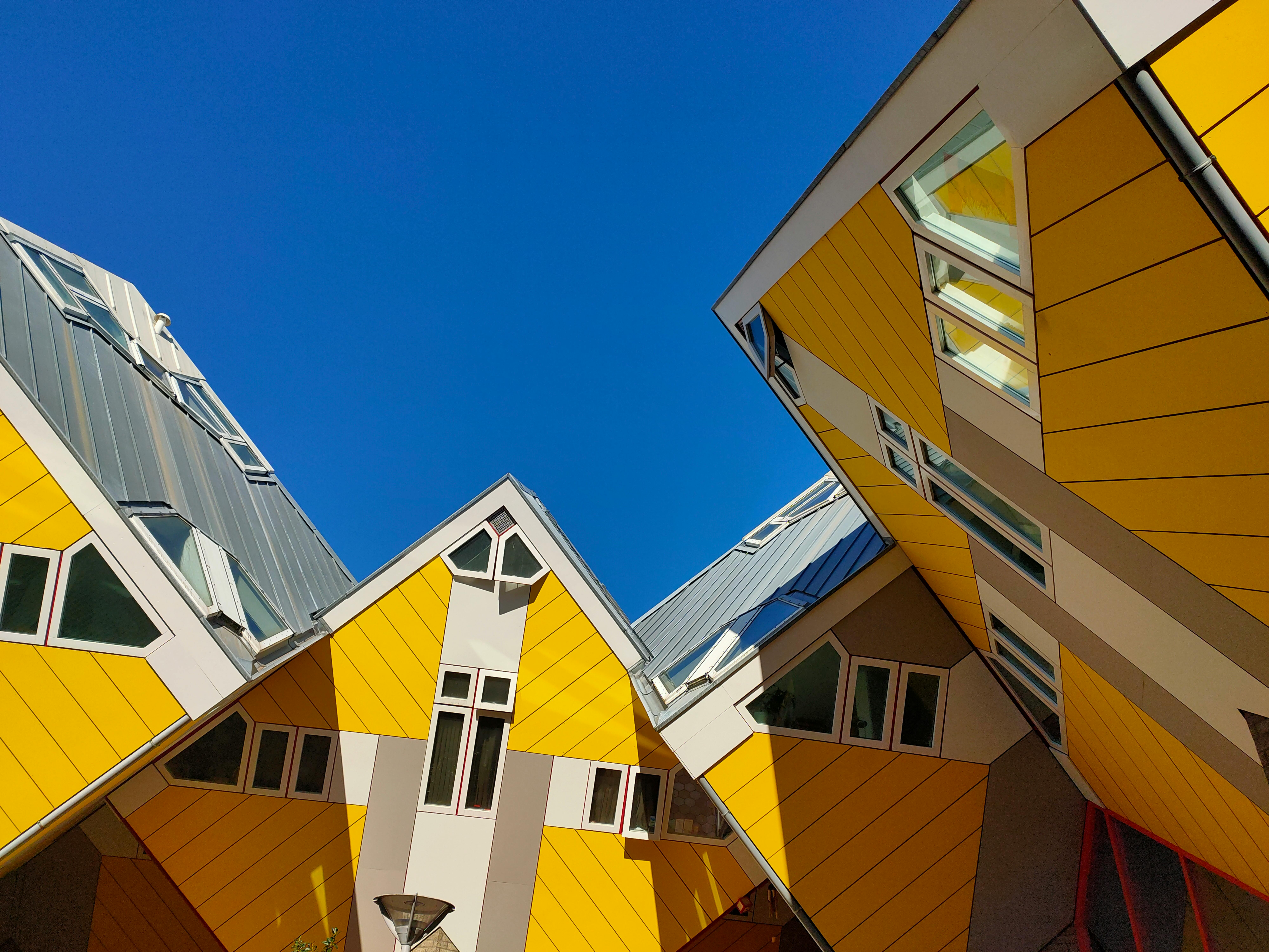 Low-angle shot of a wooden house showcasing its unique architectural styles and design features.
