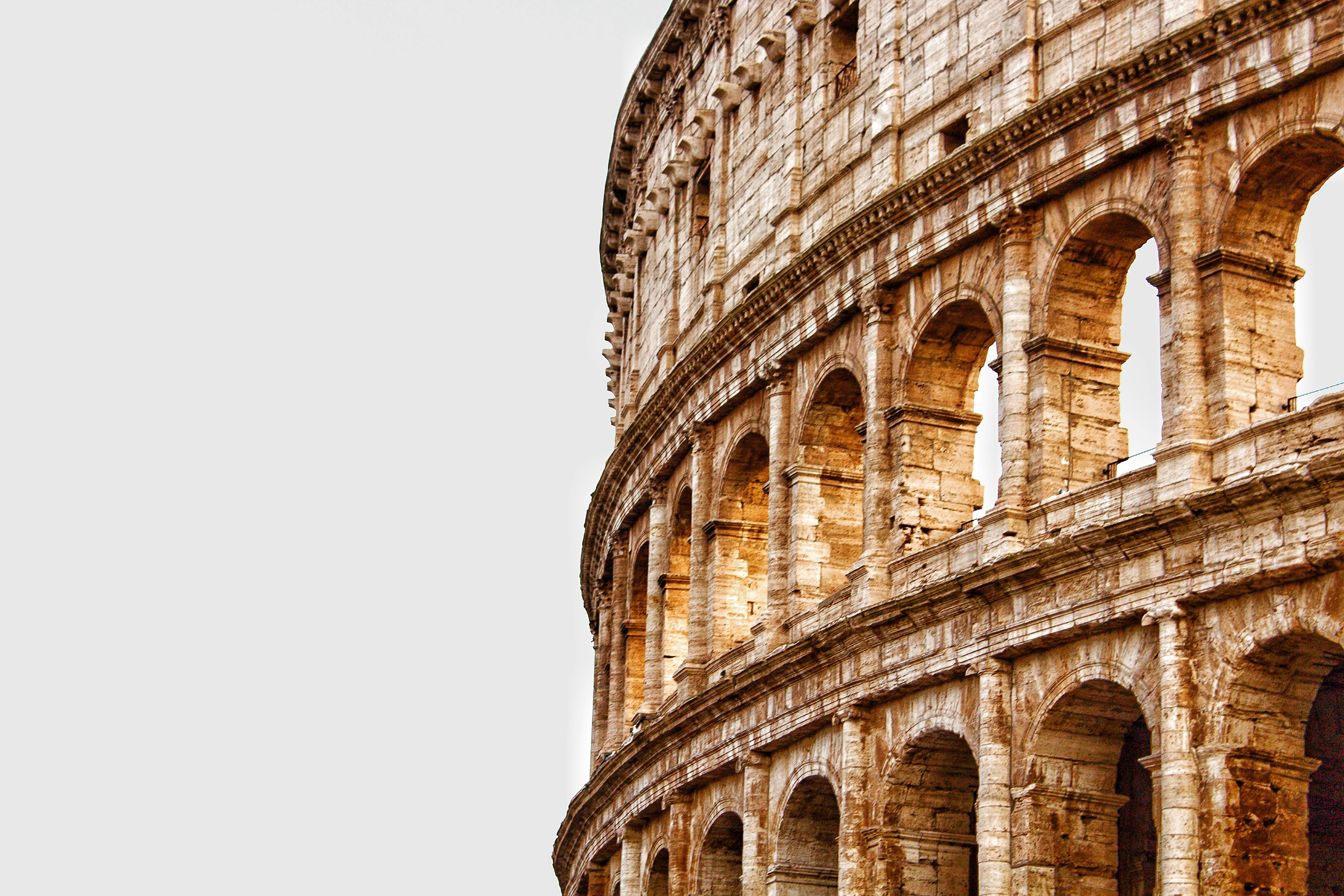 The Colosseum in Rome under clear skies.