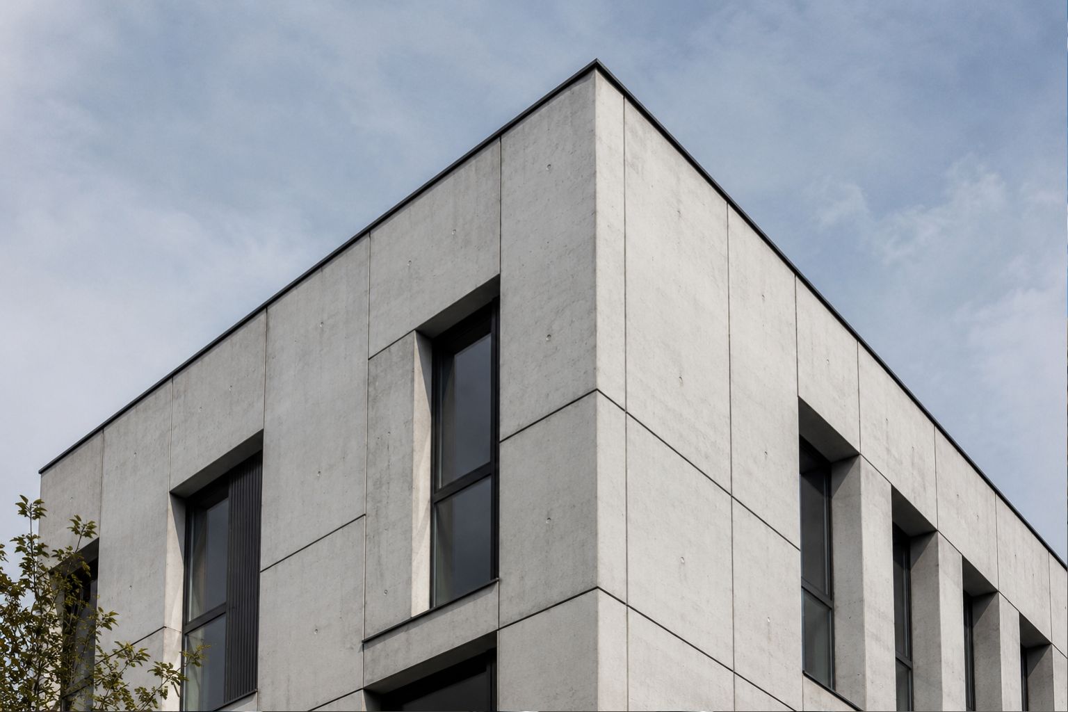 Modern concrete facade with strong geometric planes, crisp edges, and shadow lines showing how concrete can create a clean and sculptural exterior surface.