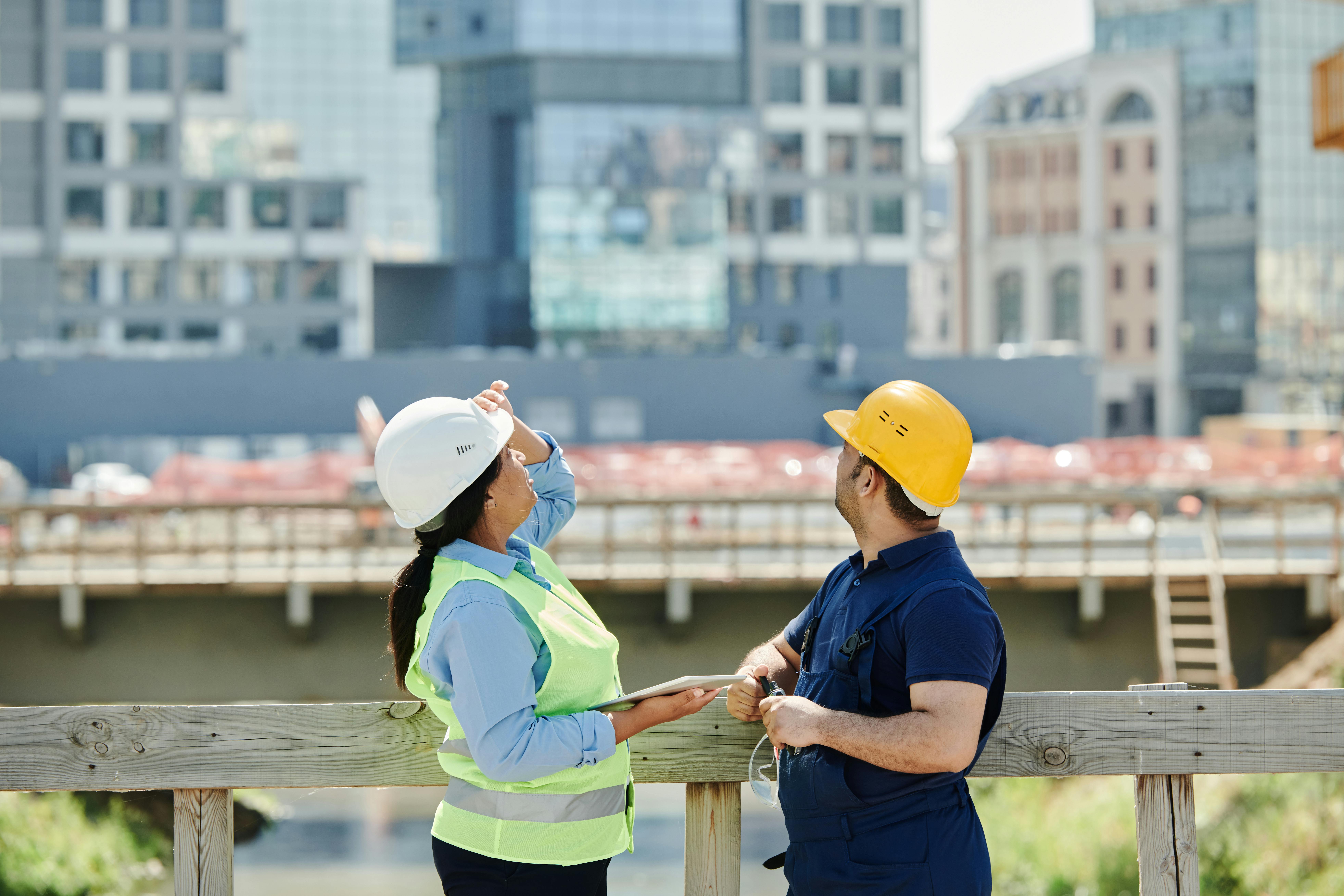Two managers standing at a construction site.