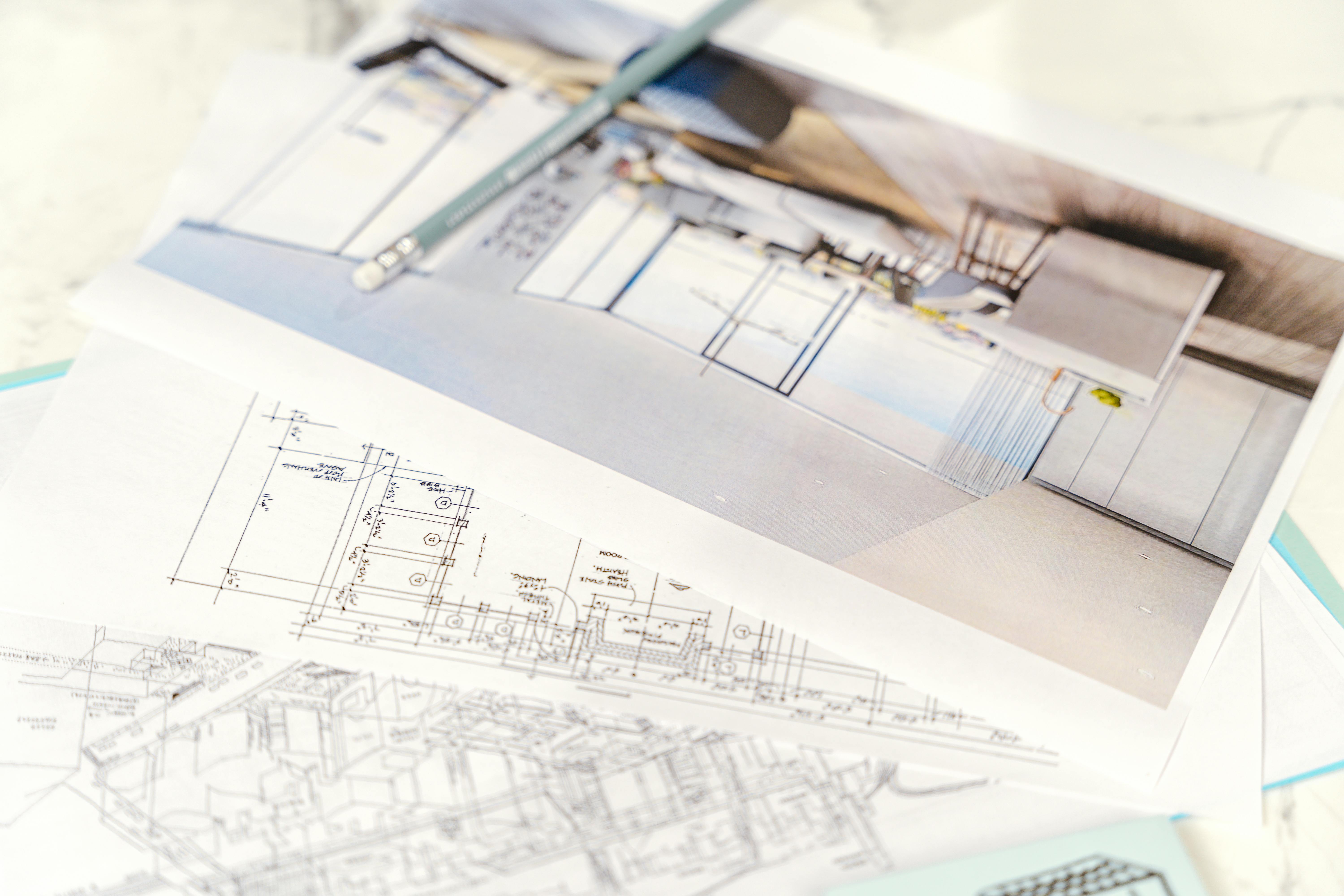 Floor plan on white paper showing architectural design stages.