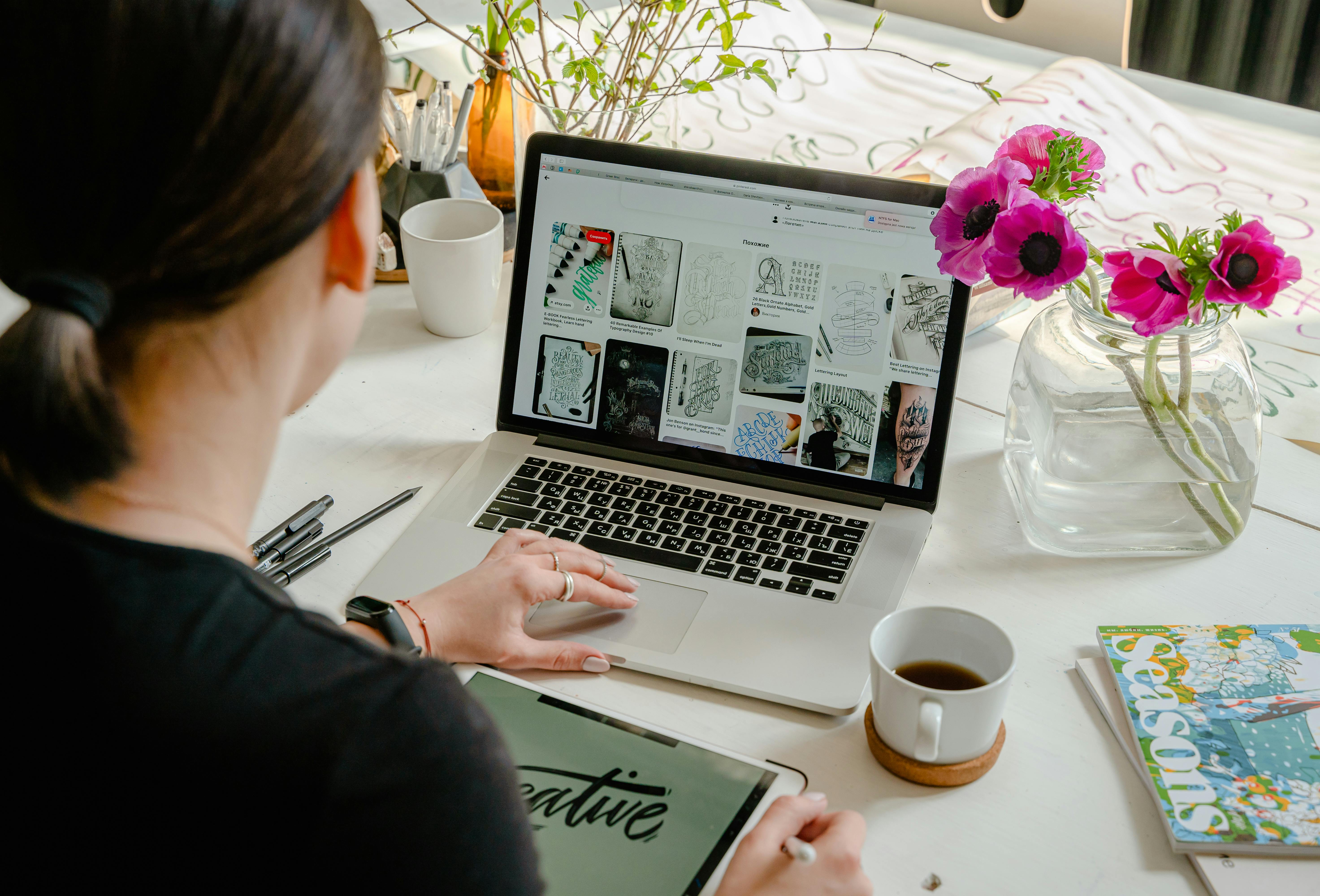 Person using laptop for graphic design work.