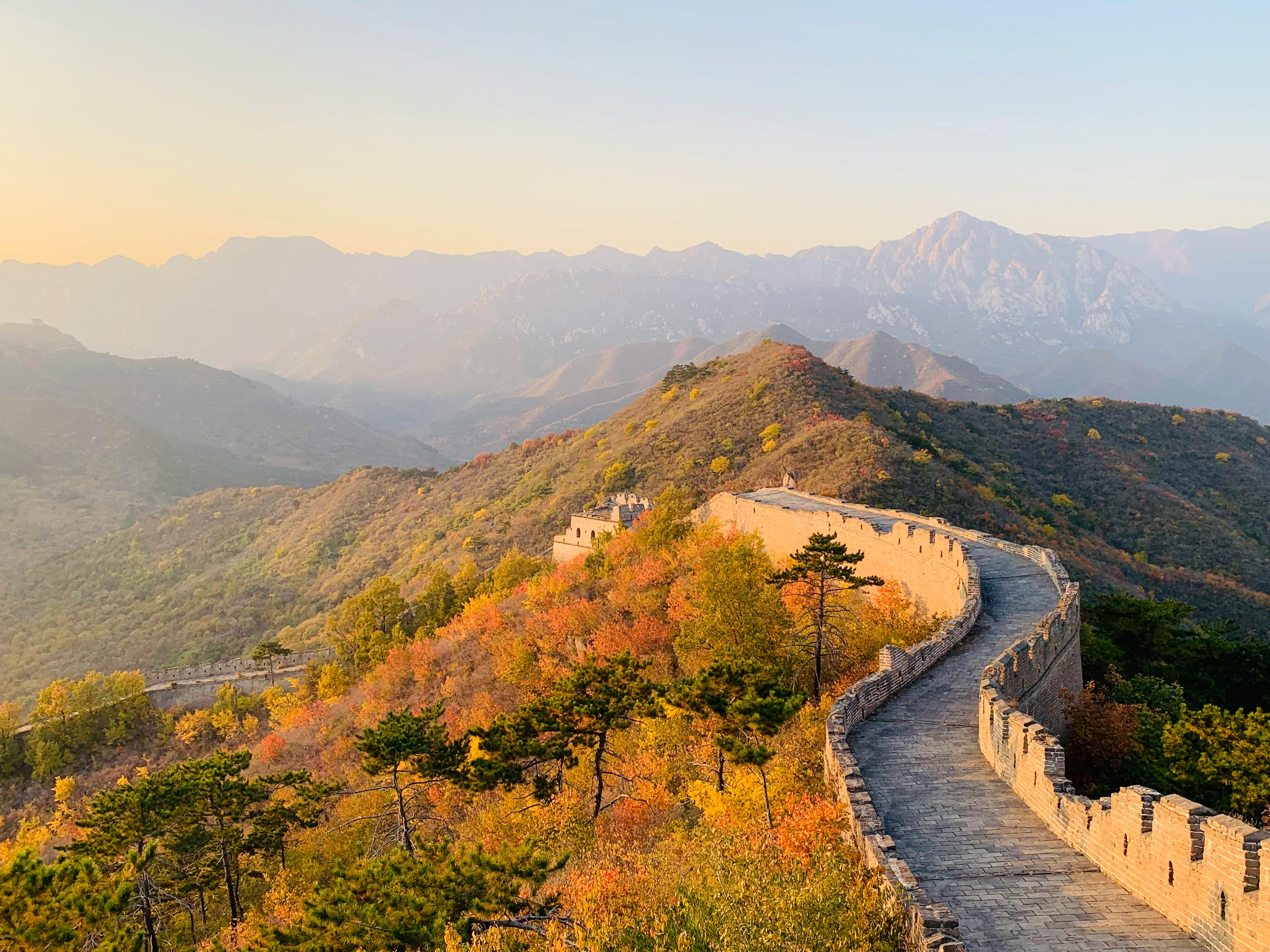 The Great Wall of China across green hills.