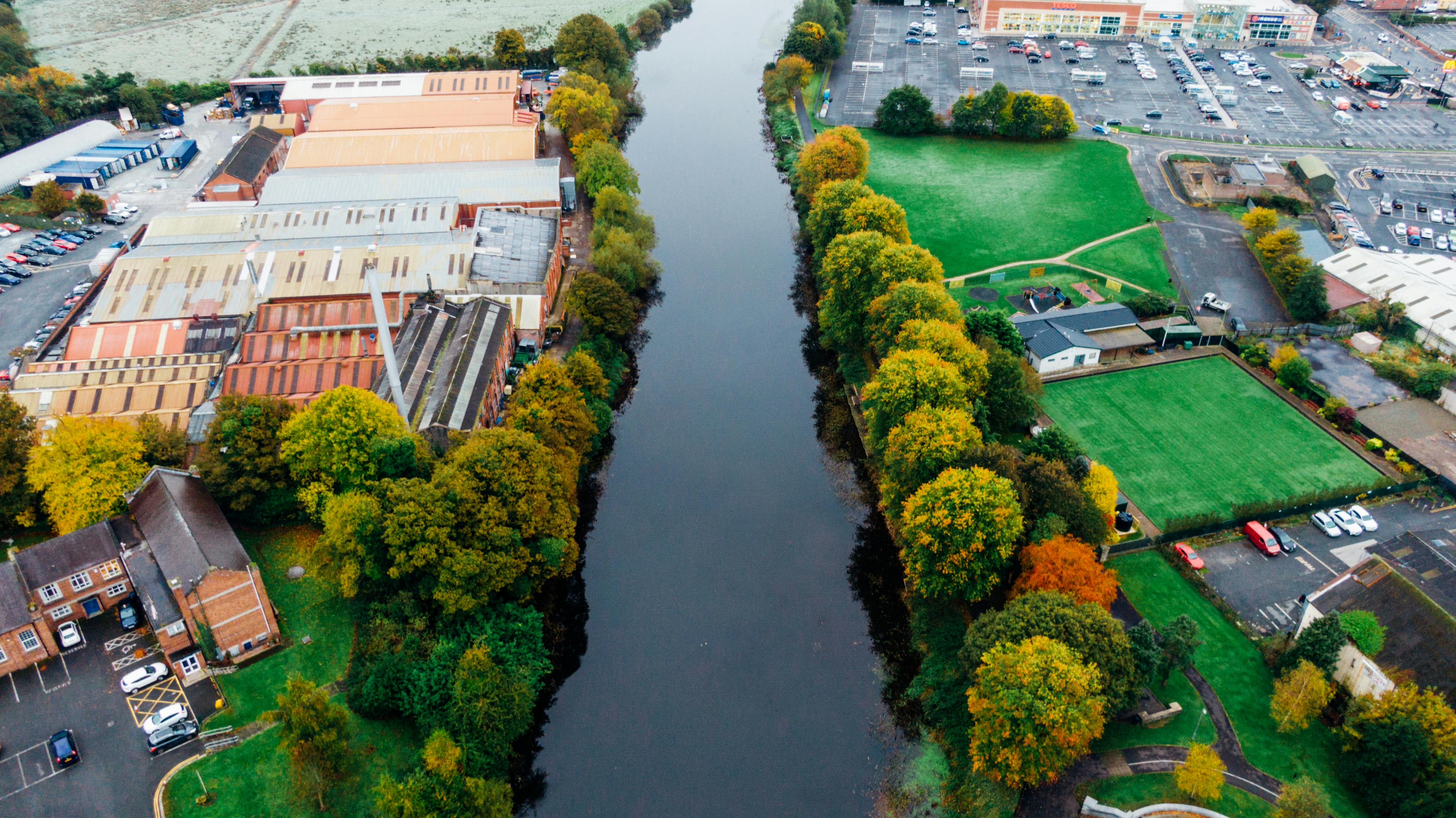 Group of industrial buildings with storage near a river.