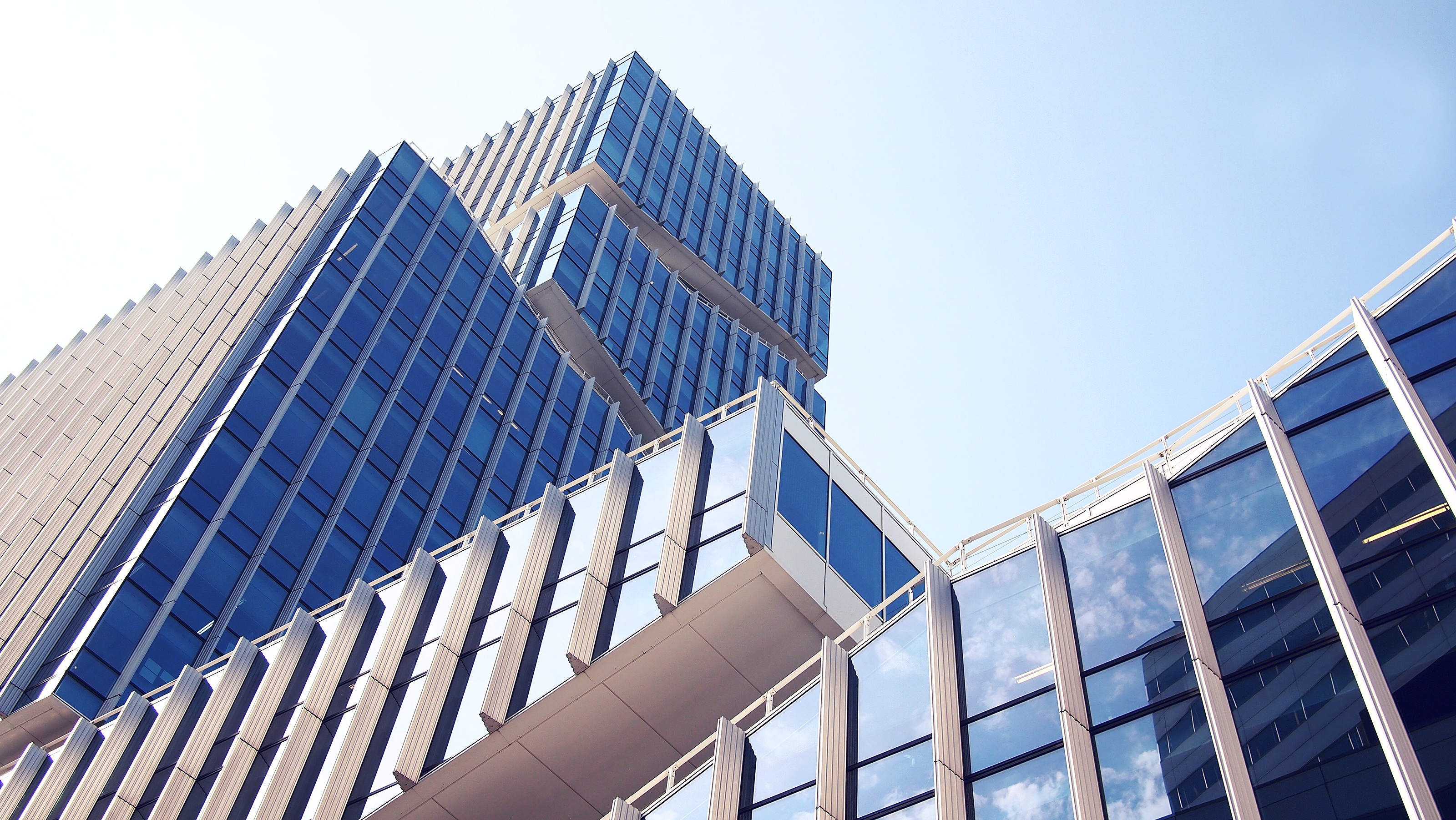 Glass commercial office tower in an urban downtown setting.
