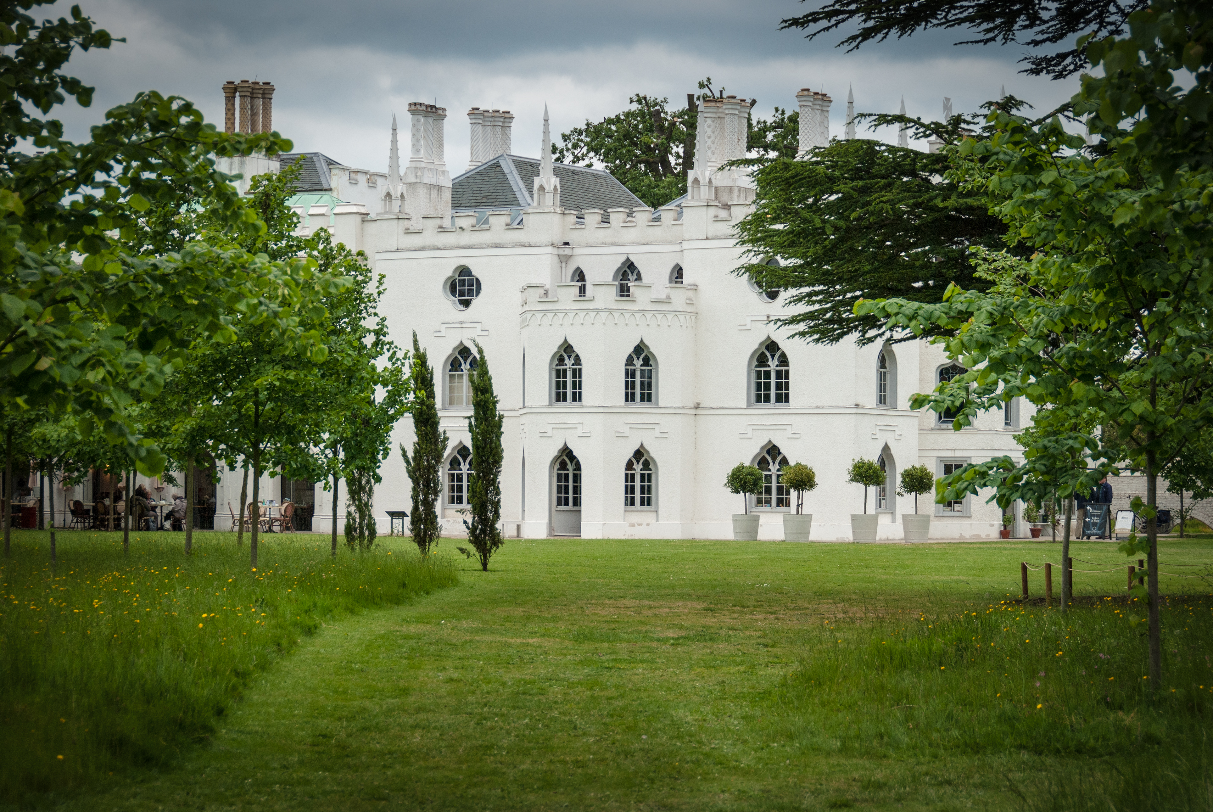 Gothic Revival house with ornate white exterior and pointed arches.