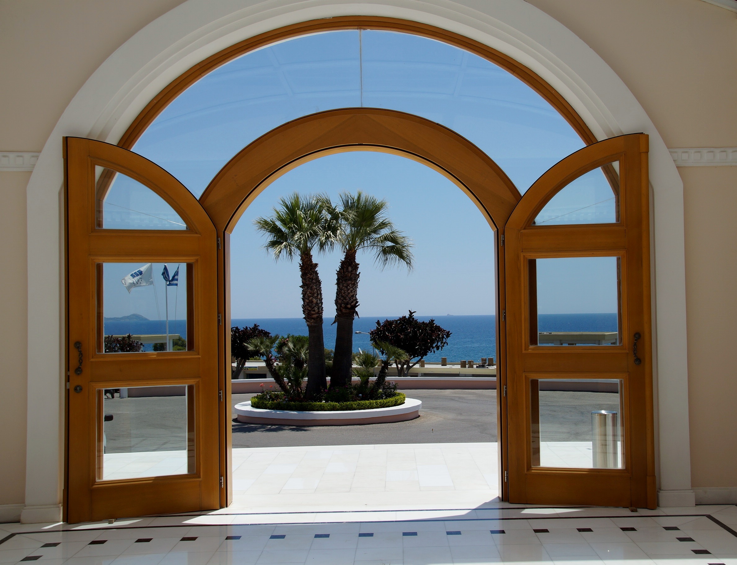 Arched windows integrated into a Mediterranean villa door.