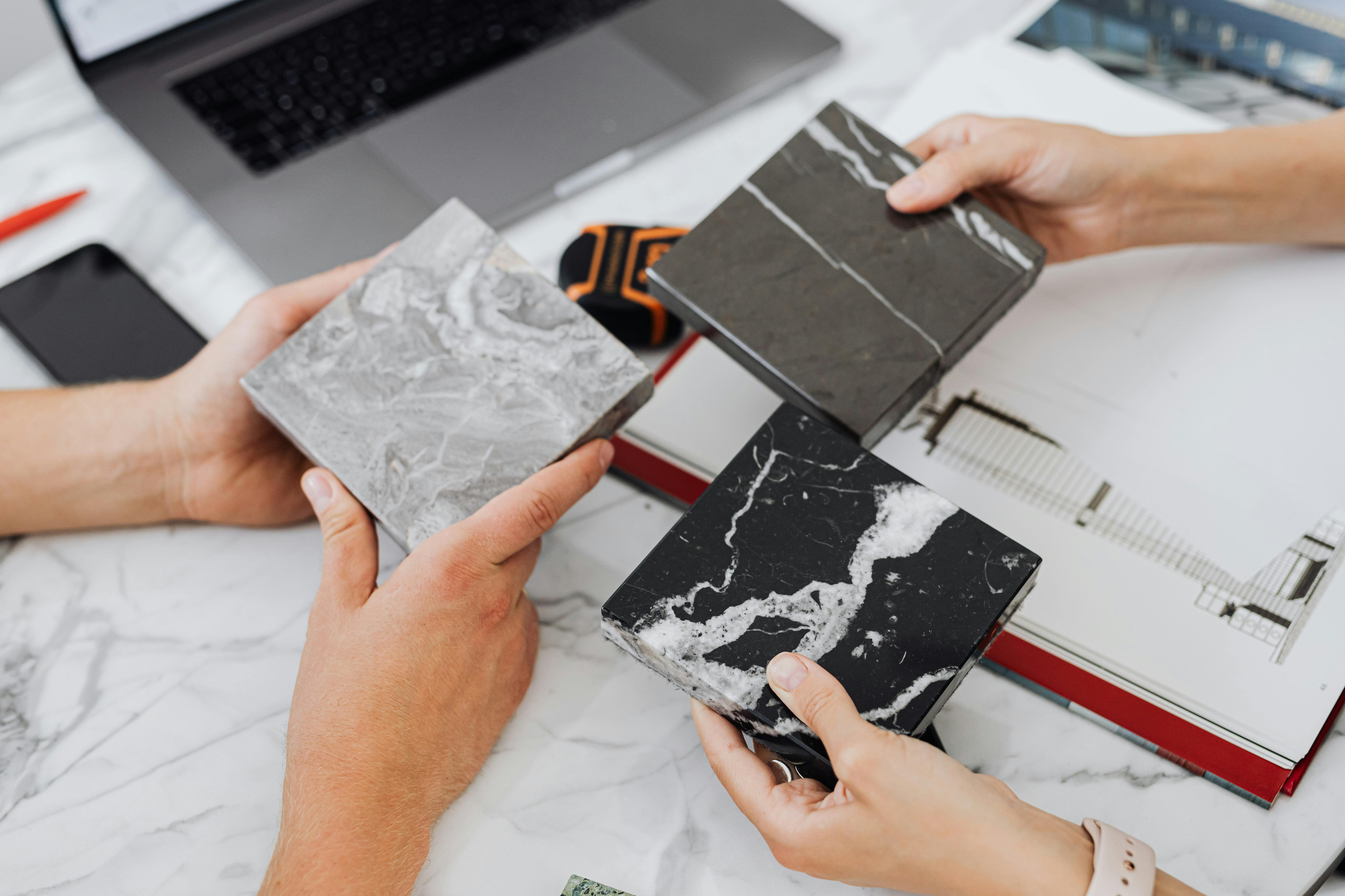 Architect examining material samples on table.