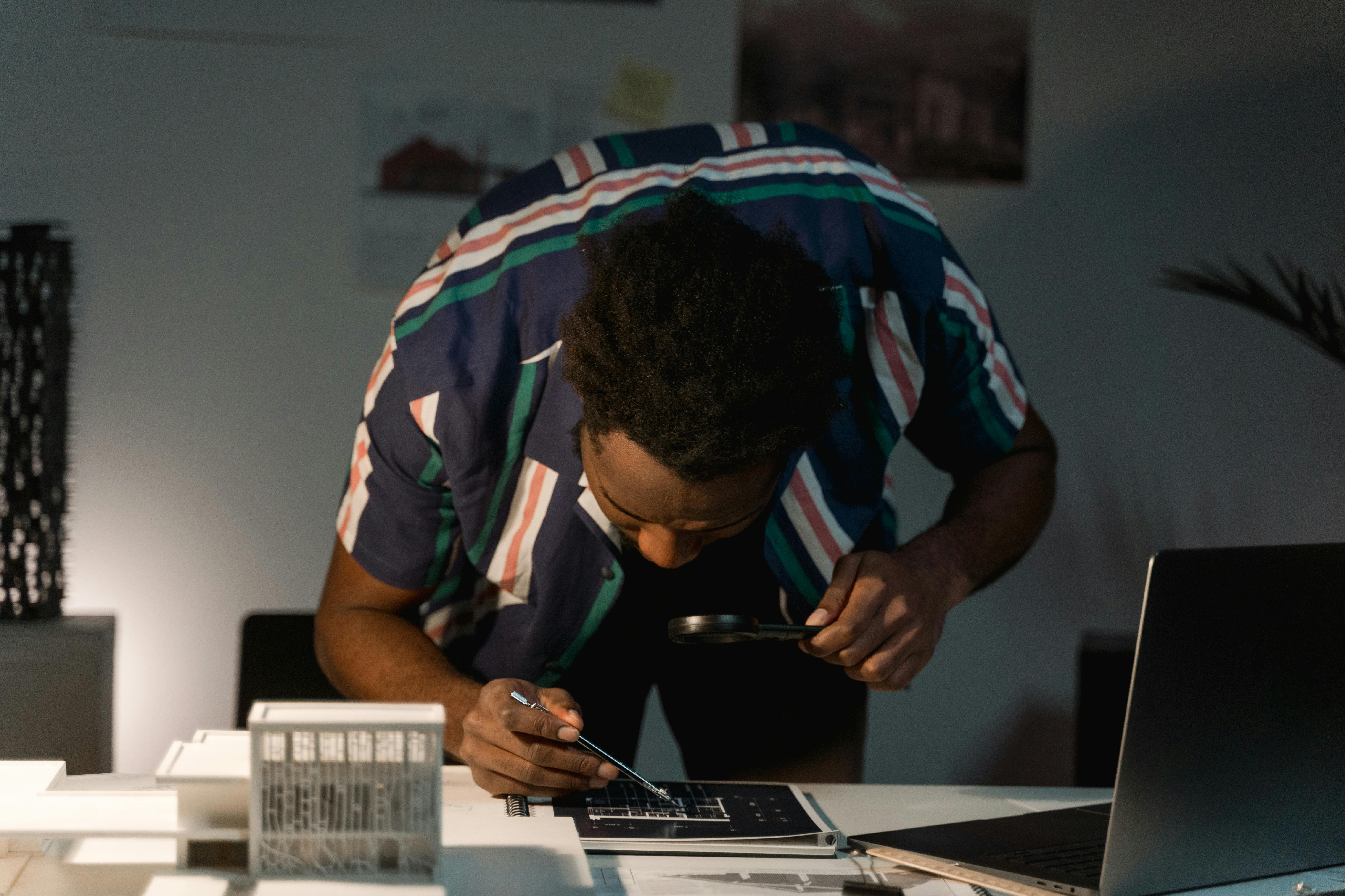 Architecture student focused on completing a blueprint design.