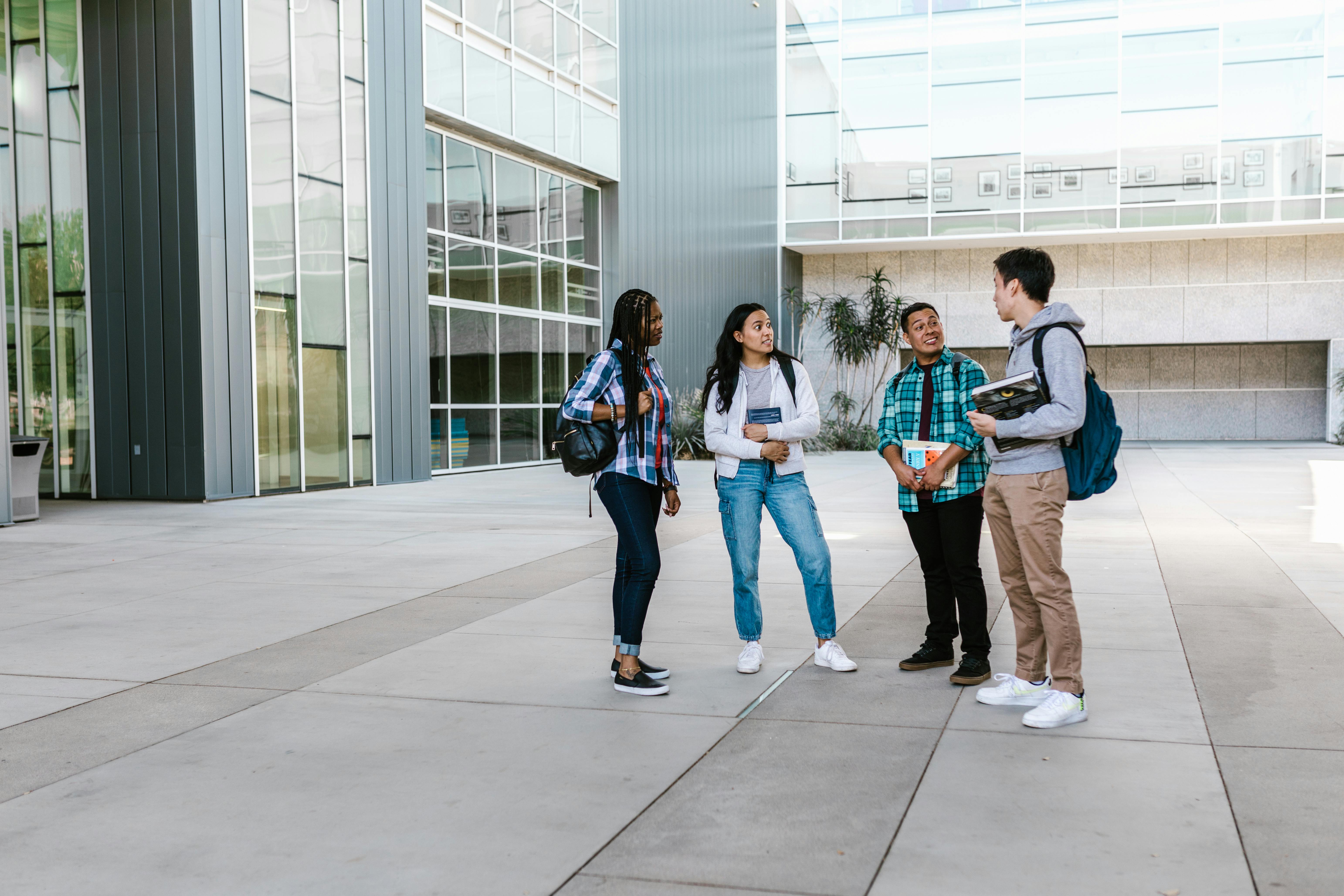 Group of architecture students walking toward university building.