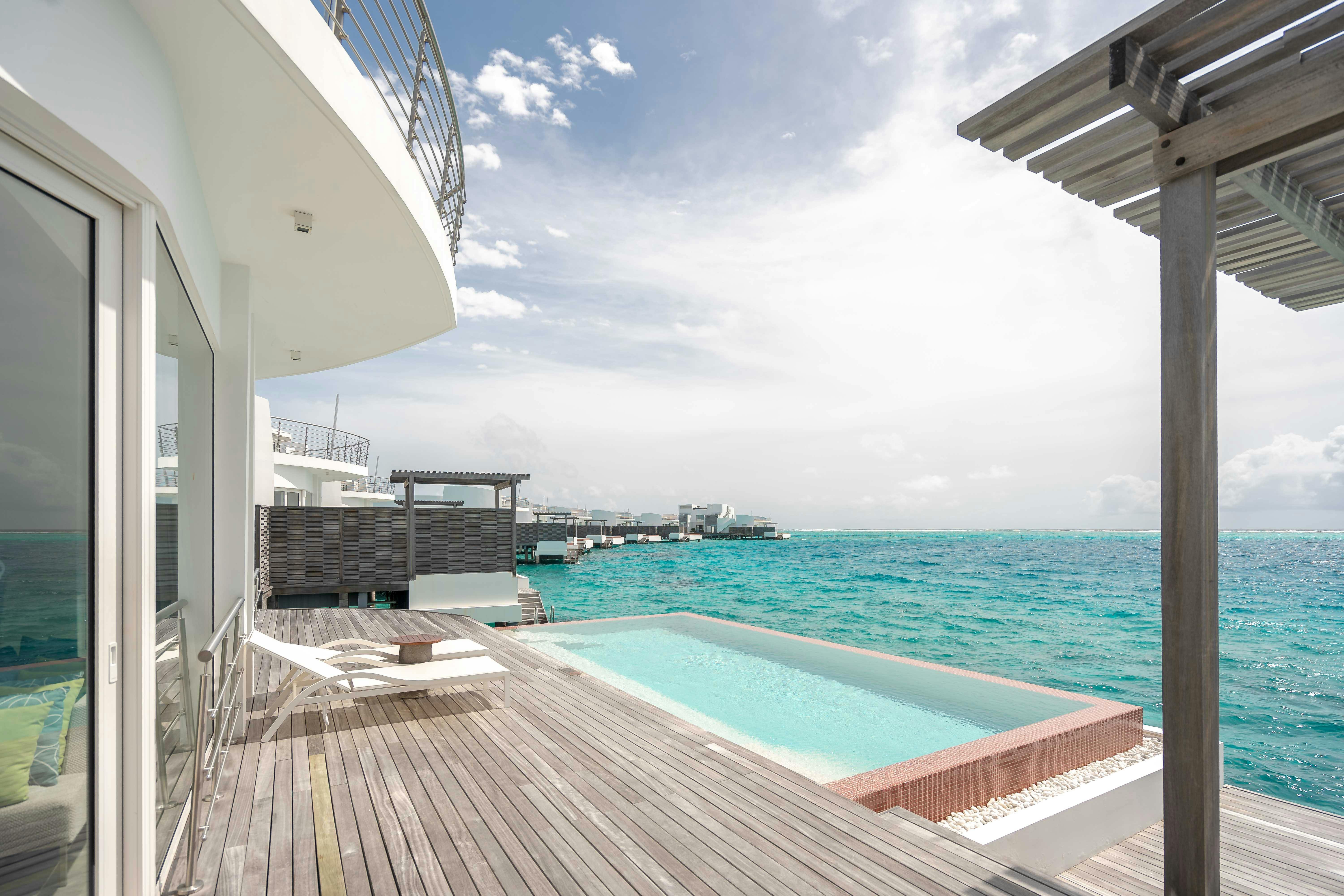 Beachfront villas with visible pools and open coastal views.