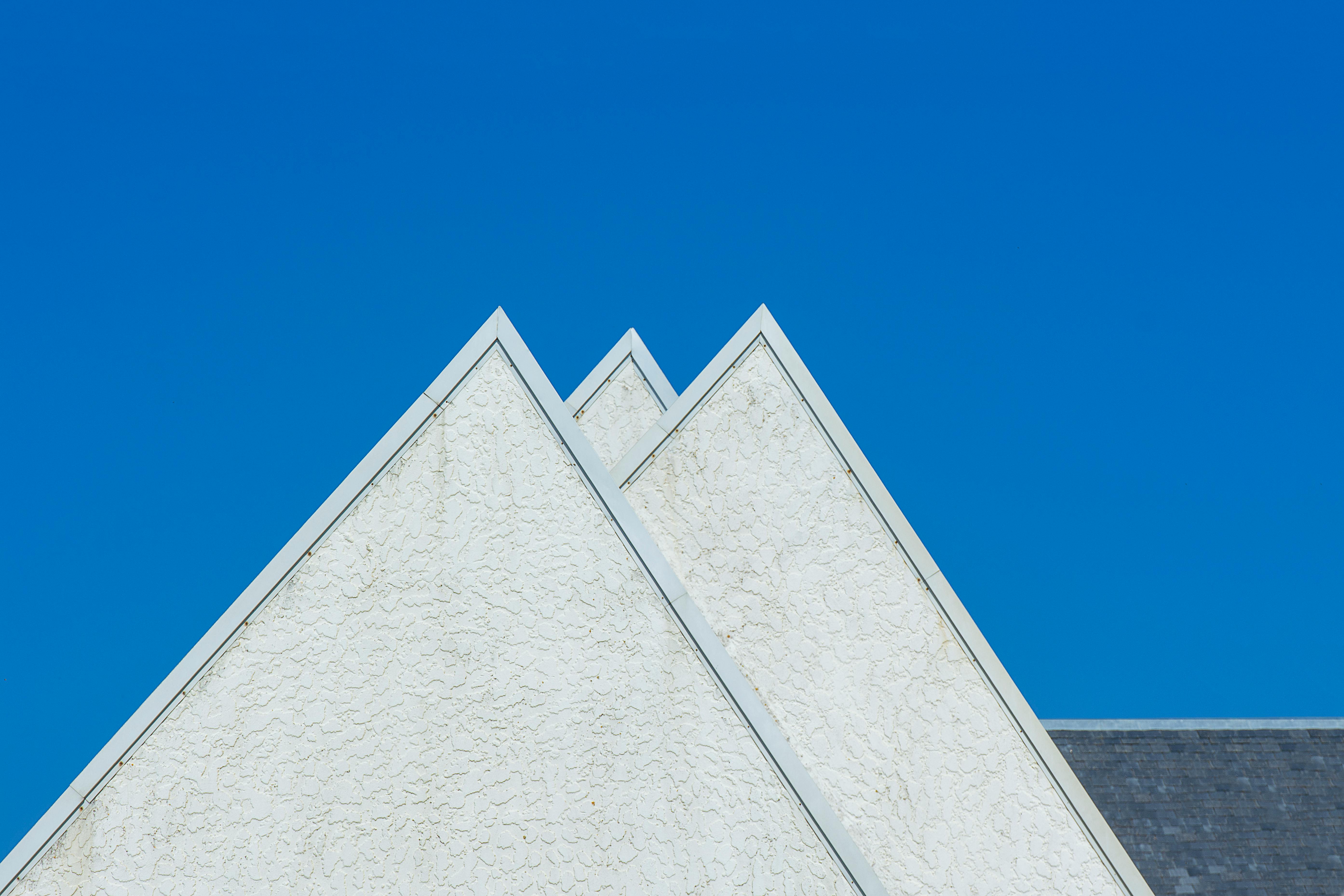Triangular concrete walls on a modern house simple front.