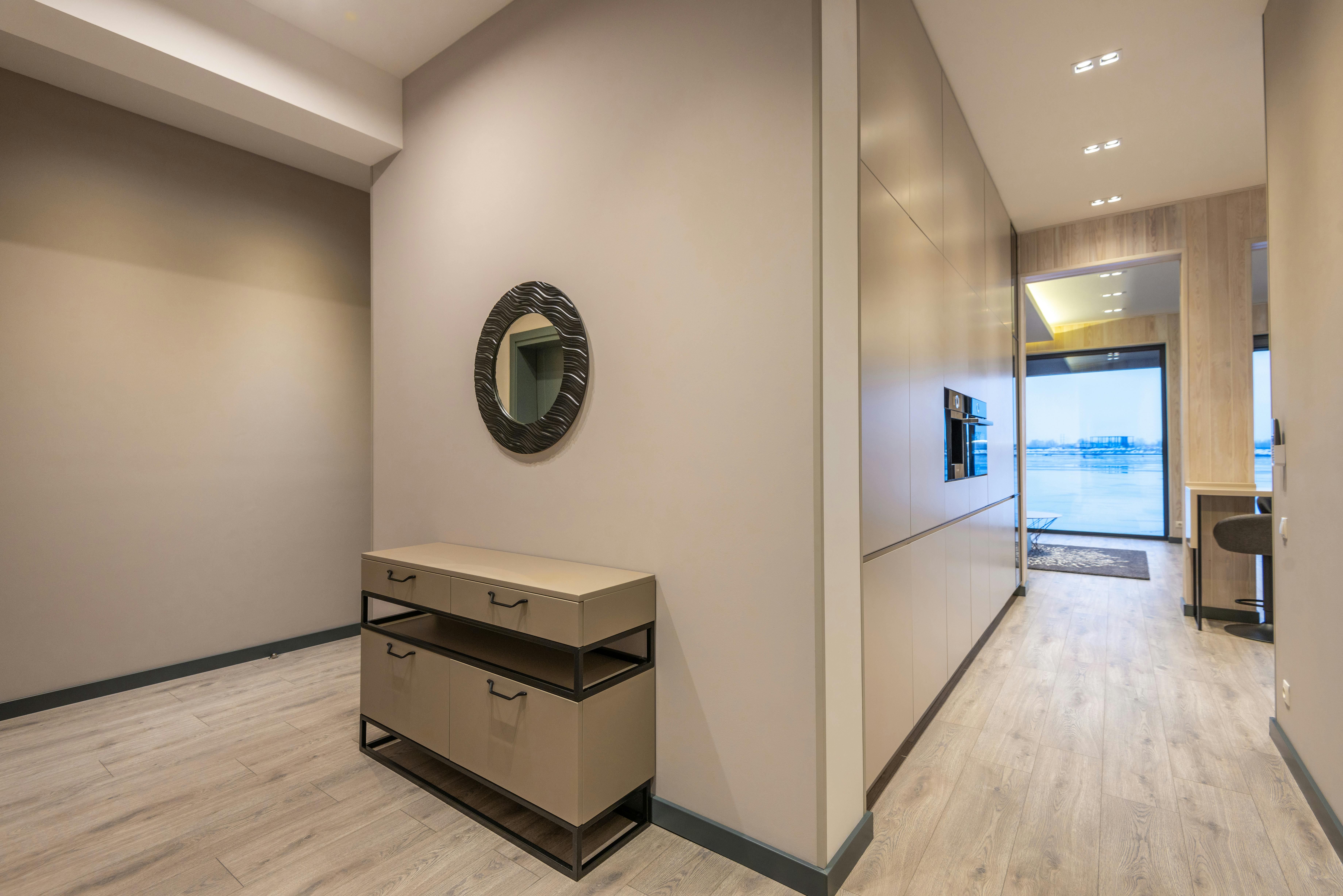 Spacious corridor in a contemporary villa with minimalist design and warm neutral tones.