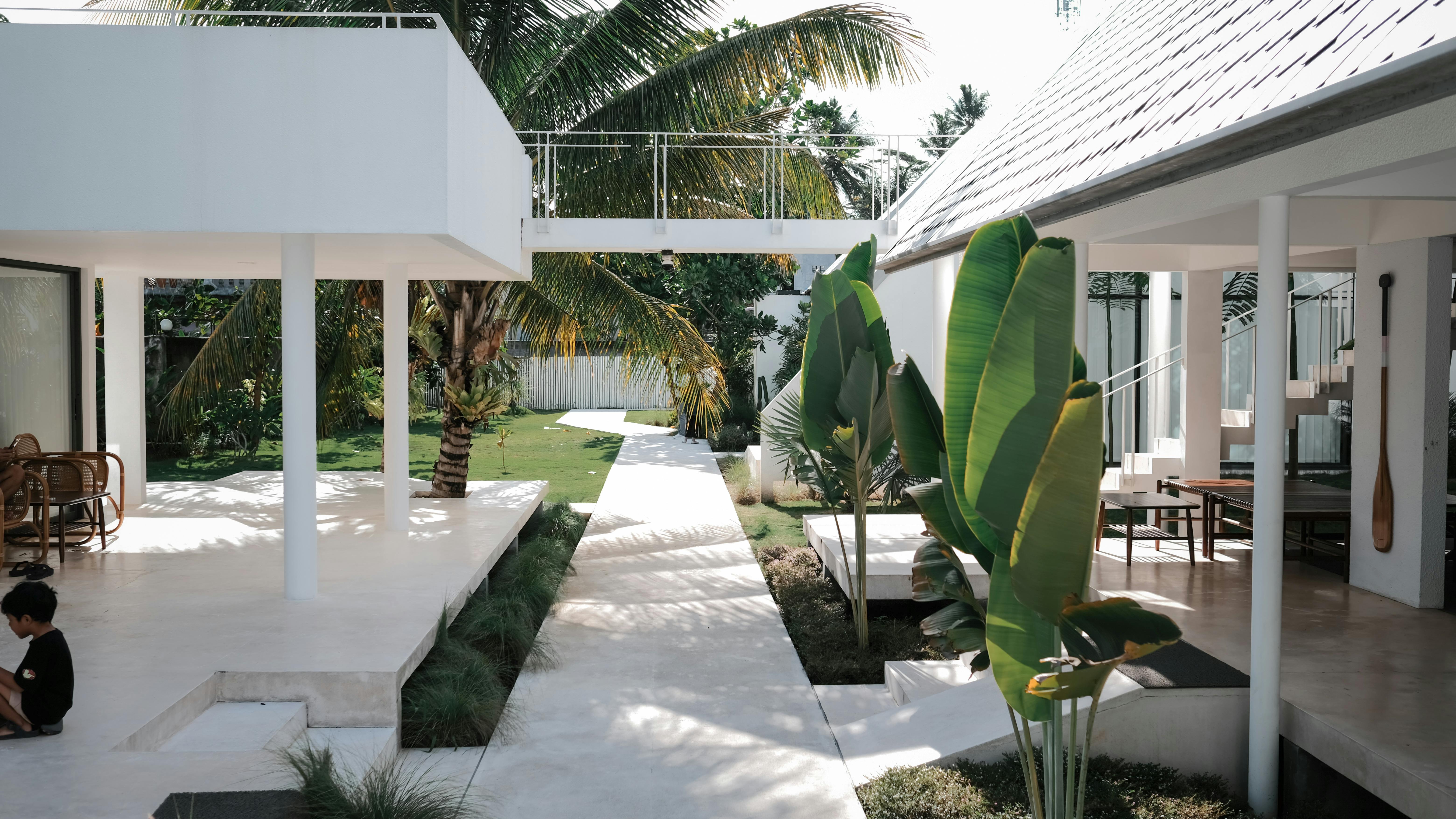 Courtyard of a Mediterranean villa house with garden and outdoor seating area.