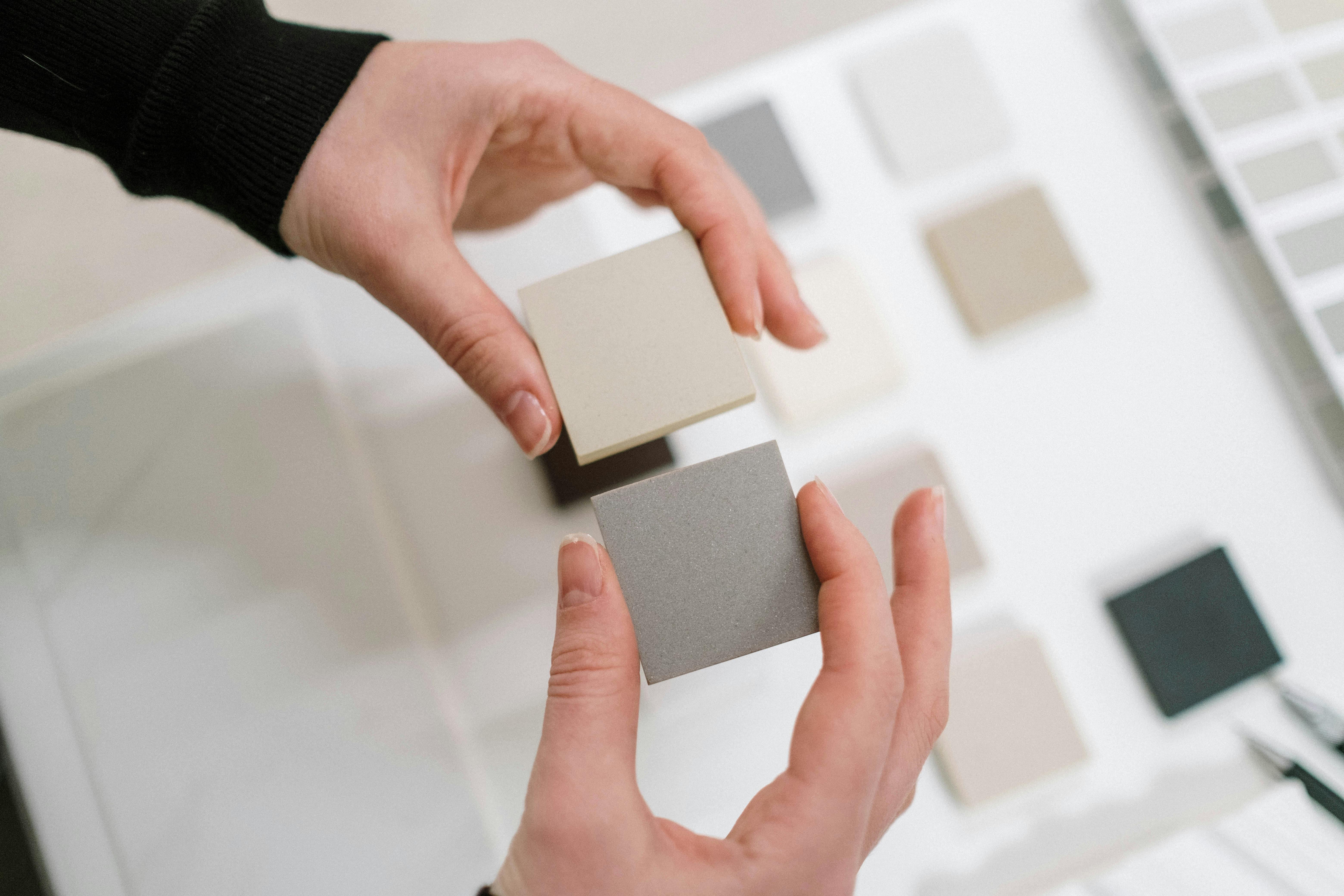 Interior designer holding samples of soft earthy tones and natural materials.